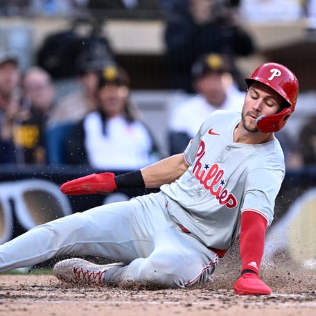 Trea Turner slides to score a run against the Padres.