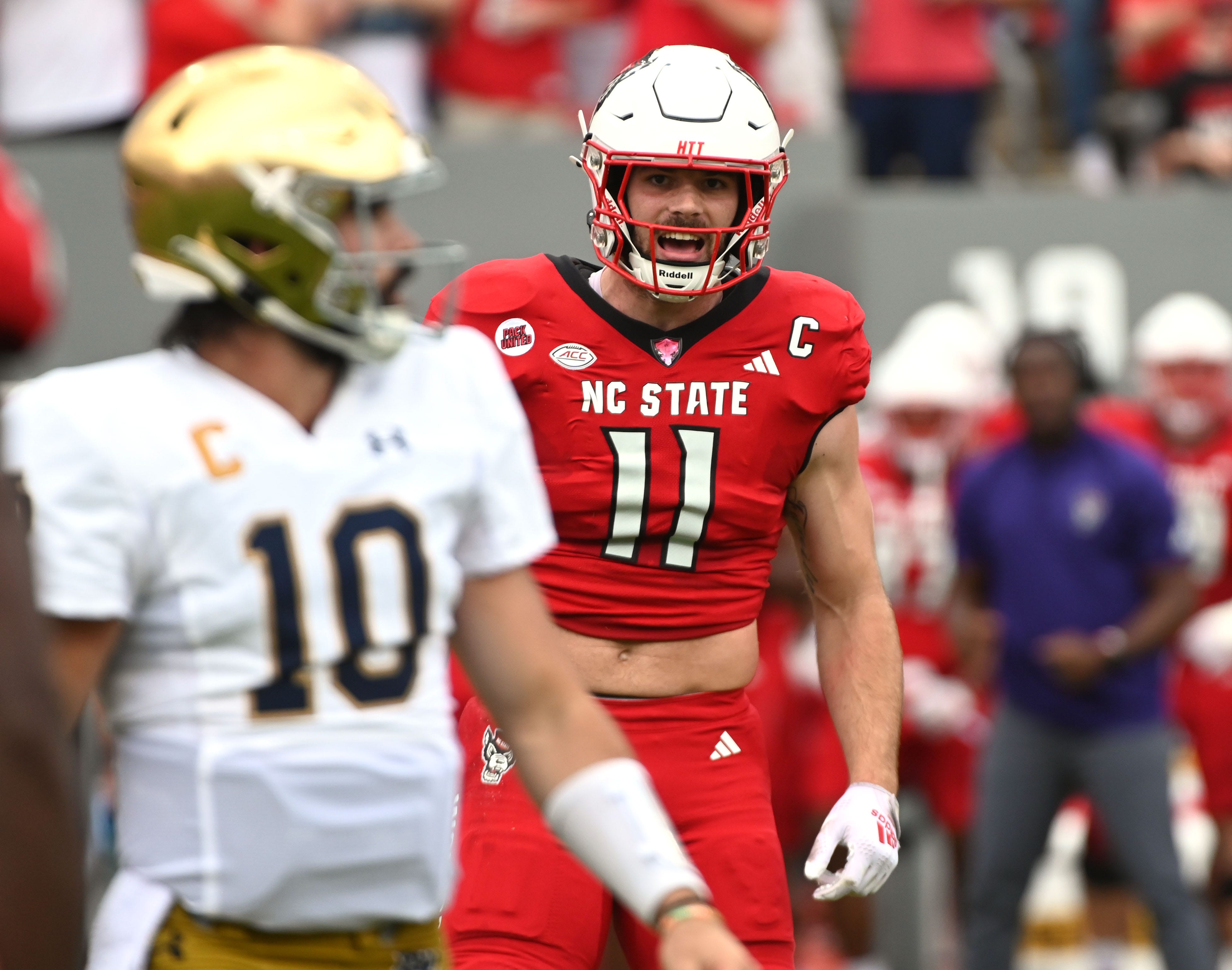 North Carolina State Wolfpack linebacker Payton Wilson (11) yells in the direction of Notre Dame Fighting Irish quarterback Sam Hartman (10) during the first half at Carter-Finley Stadium.