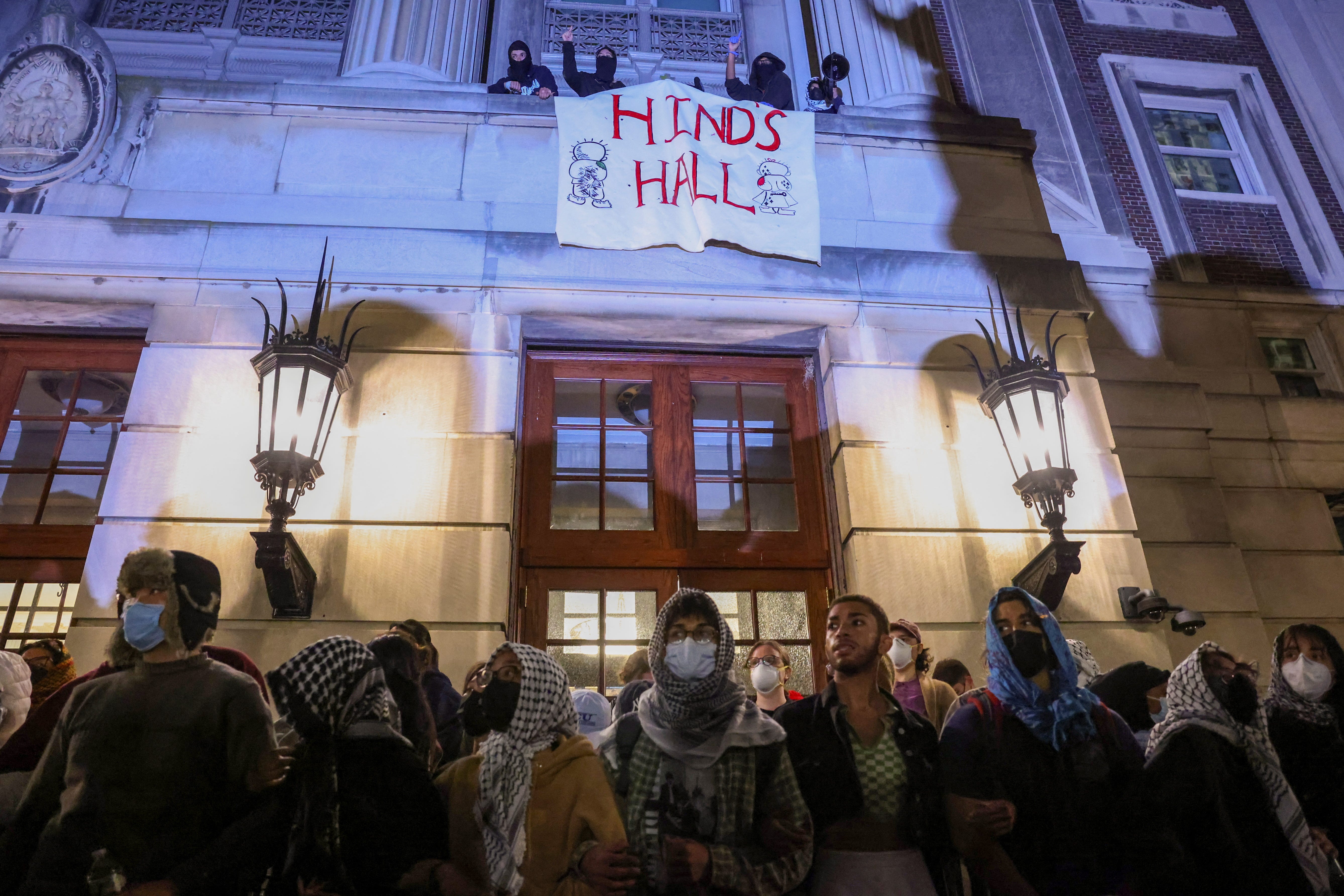 Protesters link arms outside Hamilton Hall barricading students inside the building at Columbia University in New York City, U.S., April 30, 2024.