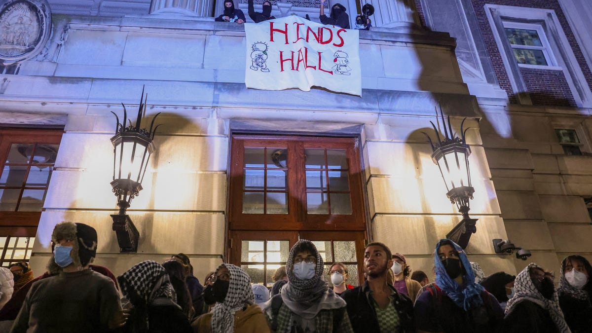 Protesters link arms outside Hamilton Hall barricading students inside the building at Columbia University in New York City, U.S., April 30, 2024.