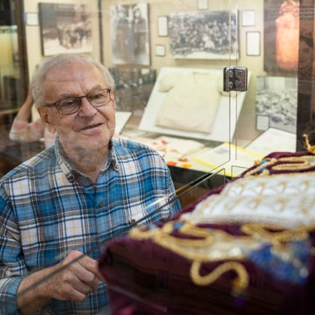 Holocaust survivor Fred Kurz admires the Distenfeld-Glick Torah scroll on display in the Esther Raab Holocaust Museum at the Jewish Community Center in Cherry Hill, NJ.
