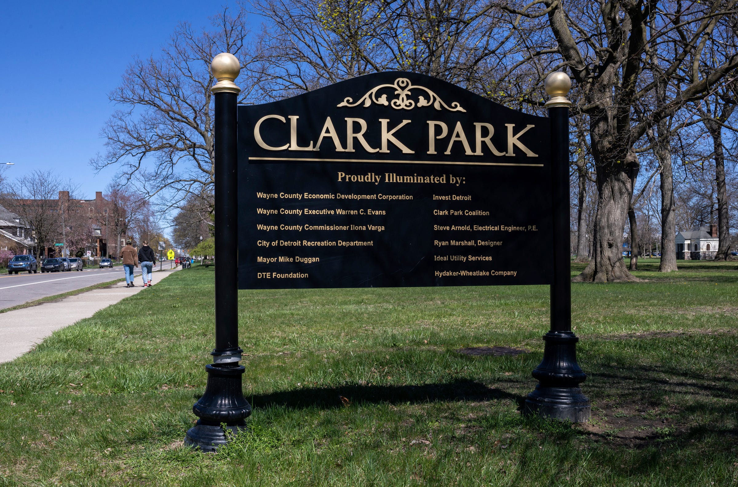 Two people walk side by side at Clark Park in southwest Detroit on Saturday, April 13, 2024.