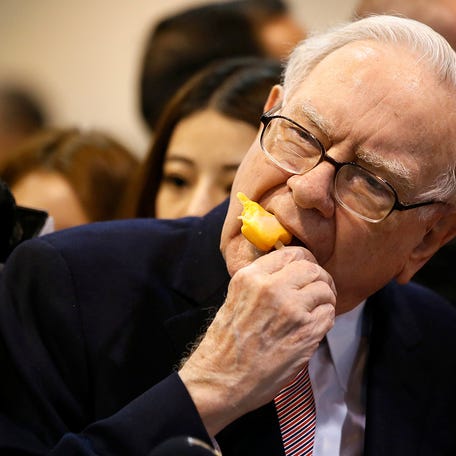Berkshire Hathaway chairman and CEO Warren Buffett enjoys an ice cream treat from Dairy Queen before the Berkshire Hathaway annual meeting in Omaha, Nebraska, on May 6, 2017.