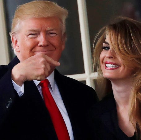 FILE PHOTO: U.S. President Donald Trump reacts as he stands next to former White House Communications Director Hope Hicks outside of the Oval Office as he departs the White House for a trip to Cleveland, Ohio, in Washington D.C., U.S., March 29, 2018. Picture taken March 29, 2018. REUTERS/Carlos Barria  TPX IMAGES OF THE DAY/File Photo