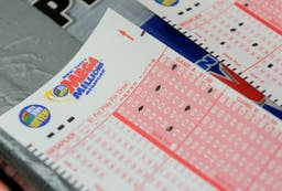 Man finds winning $1 million lottery ticket in stack of losing tickets in living room