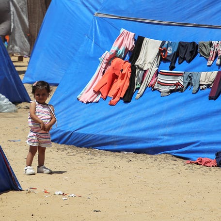 A child looks on as displaced Palestinians, who fled their houses due to Israeli strikes, shelter at a tent camp amid the ongoing conflict between Israel and the Palestinian Islamist group Hamas, in Rafah in the southern Gaza Strip, May 5, 2024.