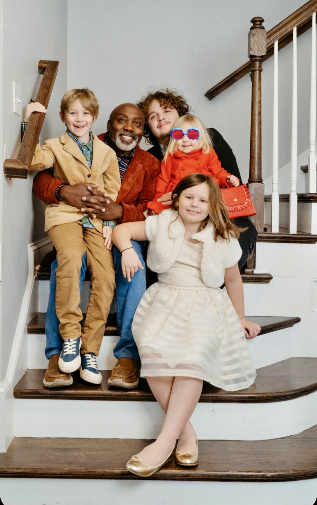 Peter Mutabazi with his three adopted kids and a child he is fostering.