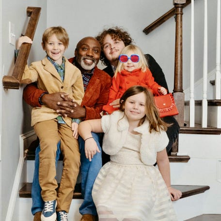 Peter Mutabazi with his three adopted kids and a child he is fostering.
