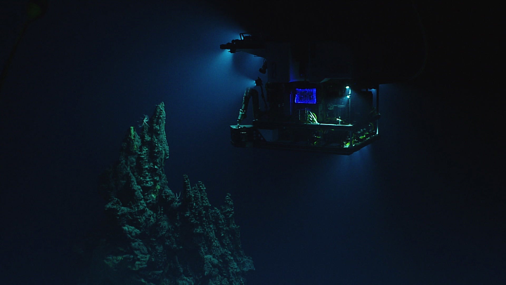 This April 28, 2016 image made available by NOAA shows the remotely operated vehicle Deep Discoverer surveying a 14-meter (46-foot) hydrothermal chimney during a deepwater exploration of the Marianas Trench Marine National Monument area in the Pacific Ocean near Guam and Saipan. Dives in the expedition ranged from 250 to 6,000 meters (820 feet to 3.7 miles) deep.