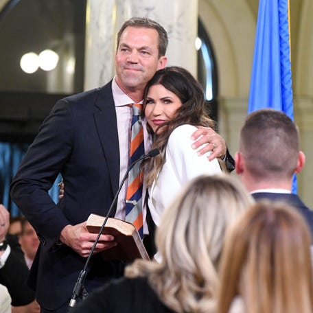 Bryon Noem hugs his wife, South Dakota Gov. Kristi Noem, after she takes the oath of office to begin her second term on Jan. 7, 2023, at the state Capitol in Pierre. The governor would become the head of the Department of Homeland Security in 2025.