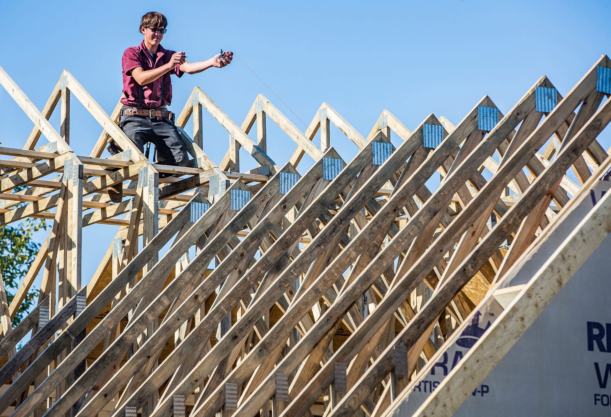 A crew with Richmond-based Trademark Construction builds a home in the Pineview at Riverside neighborhood in 2021. Owner Terry Robinson said supply chain disruptions affected his business.