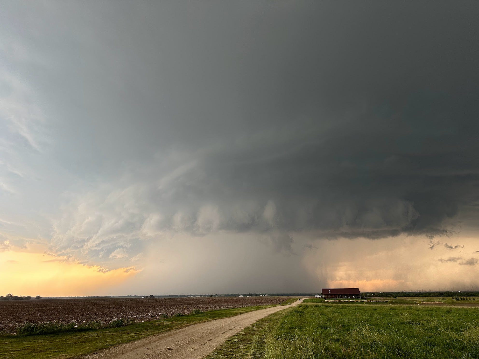 A supercell storm outside of Ponca City, Oklahoma during a storm chasing tour in May of 2024. The storm carries with it rain and large hailstones.