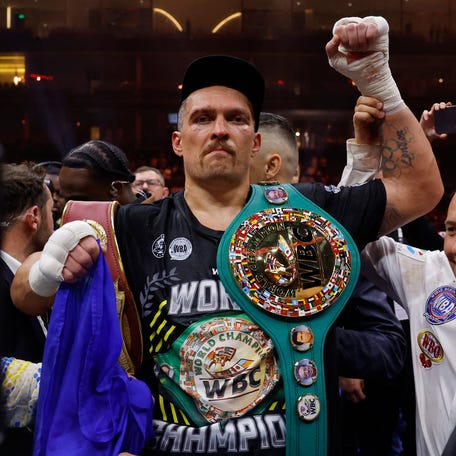 Oleksandr Usyk celebrates with the belts after beating Tyson Fury at Kingdom Arena in Riyadh, Saudi Arabia to become the undisputed heavyweight world champion on May 18, 2024.