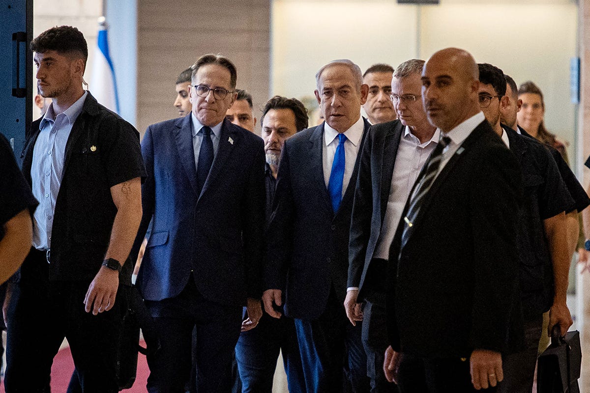 Israeli Prime Minister Benjamin Netanyahu (C) arrives for a party meeting at the Israeli parliament, the Knesset, in Jerusalem on May 20, 2024. Israel on May 20 slammed as a "historical disgrace" an application by the prosecutor of the International Criminal Court for an arrest warrant for Netanyahu.