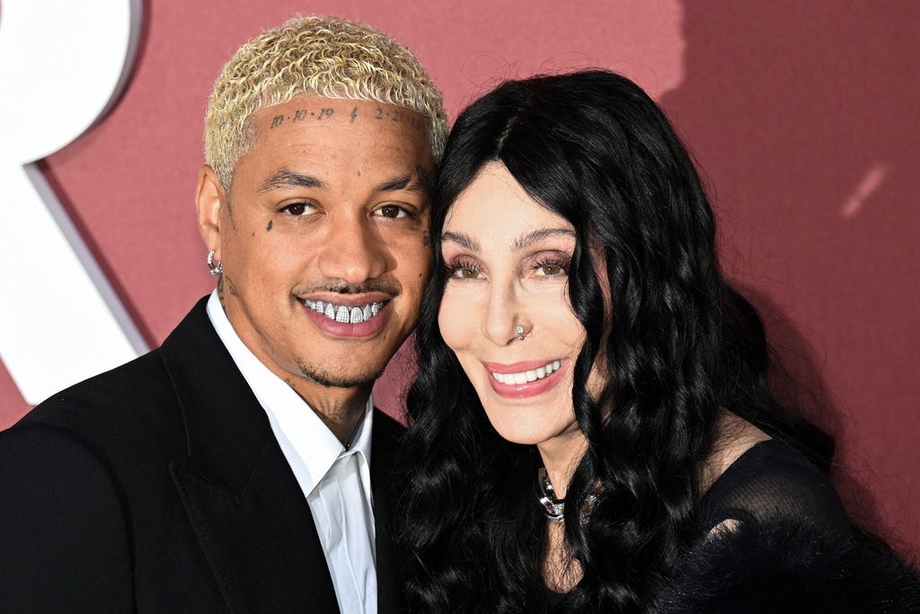 TOPSHOT - US singer Cher (R) and her boyfriend US singer Alexander Edwards arrive to attend the annual amfAR Cinema Against AIDS Cannes Gala at the Hotel du Cap-Eden-Roc in Cap d'Antibes, southern France, on the sidelines of the 77th Cannes Film Festival, on May 23, 2024. (Photo by Stefano Rellandini / AFP) (Photo by STEFANO RELLANDINI/AFP via Getty Images) ORIG FILE ID: 2153695220