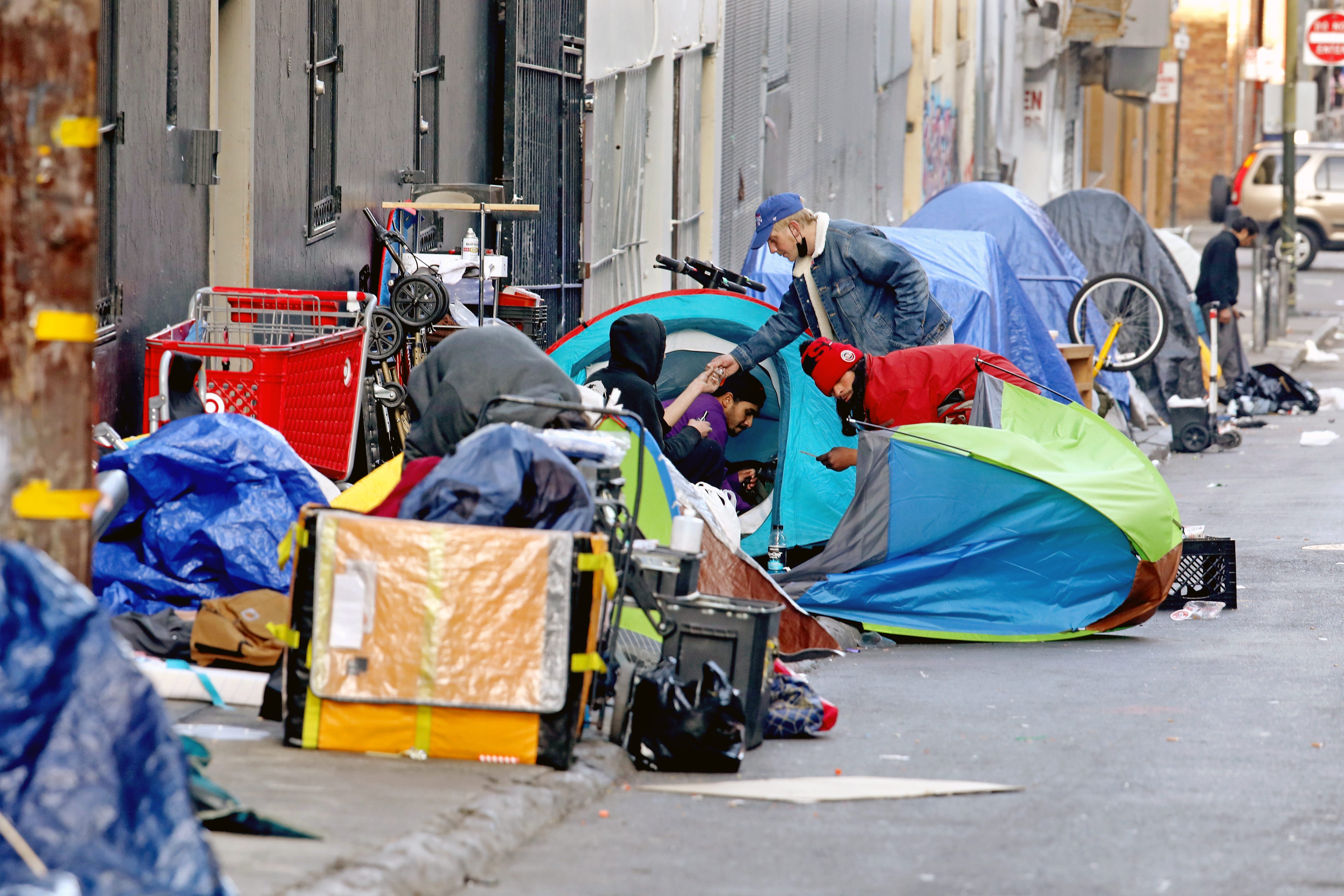 Homeless people set up an encampment along Willow Street in San Francisco's Tenderloin district in February 2022. The mayor's spokesman said the Managed Alcohol Program helps bring problematic residents 