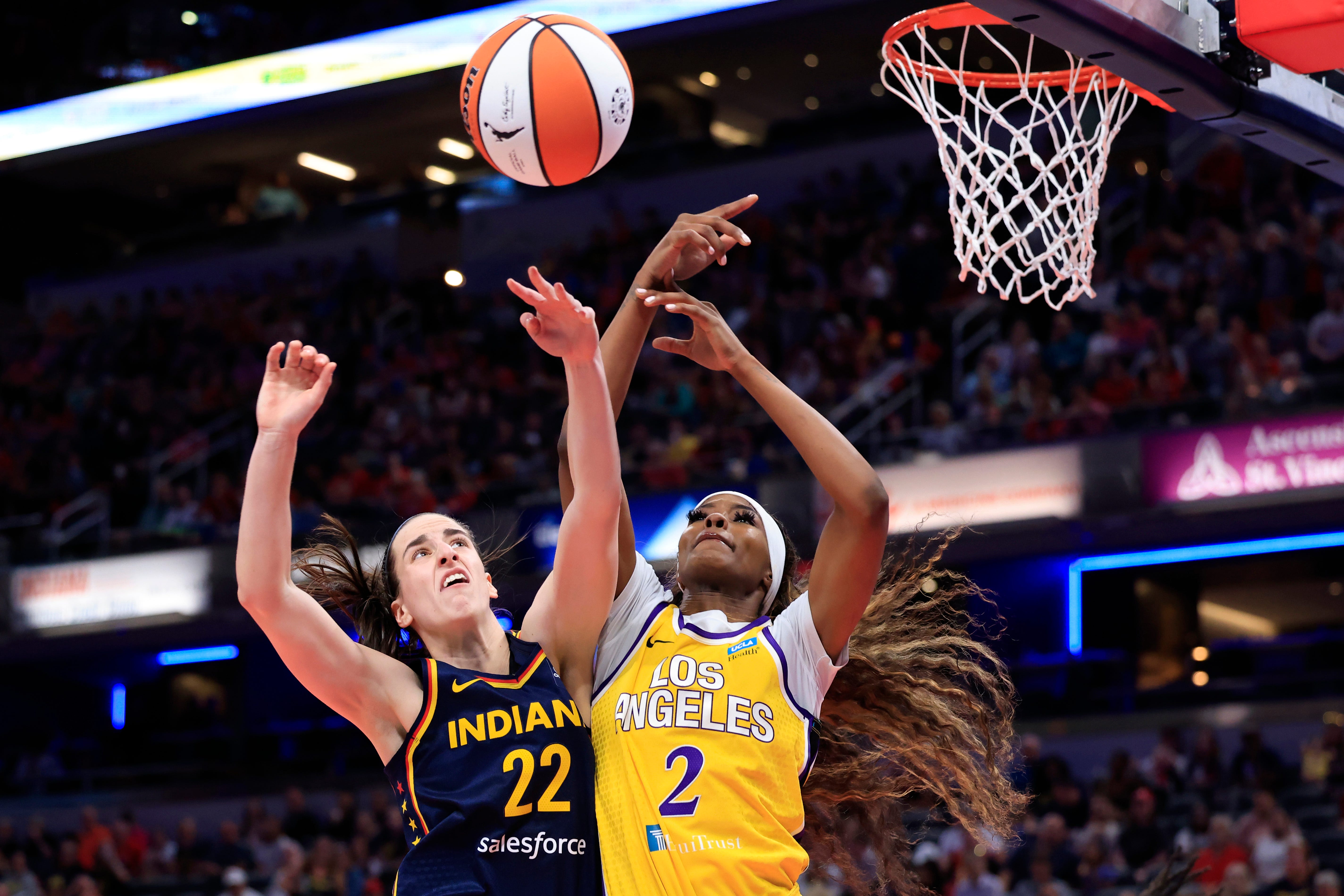 Caitlin Clark and Rickea Jackson vie for the rebound during their game in Indianapolis.