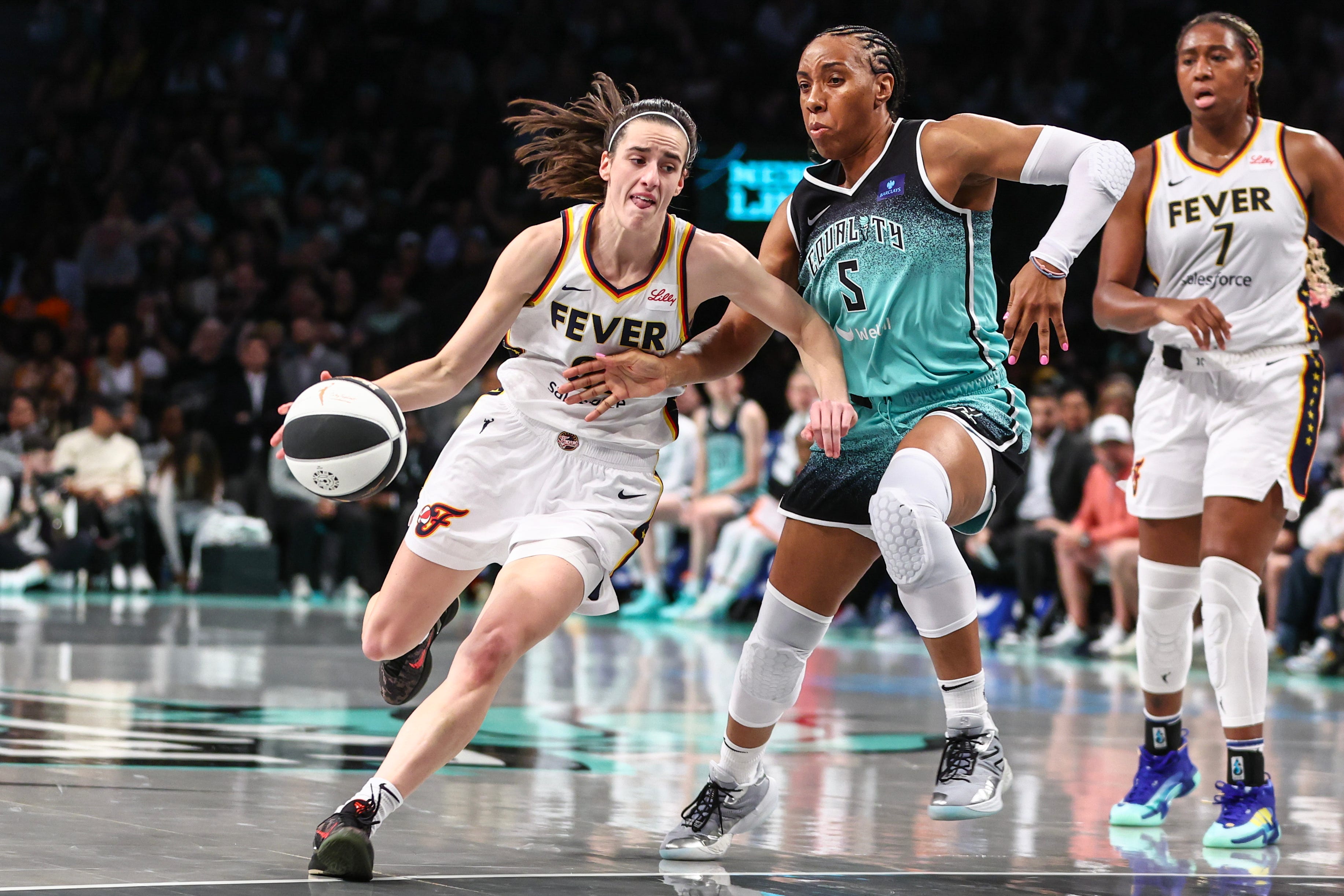 Indiana Fever guard Caitlin Clark (22) looks to drive past New York Liberty forward Kayla Thornton (5) in the second quarter at Barclays Center.