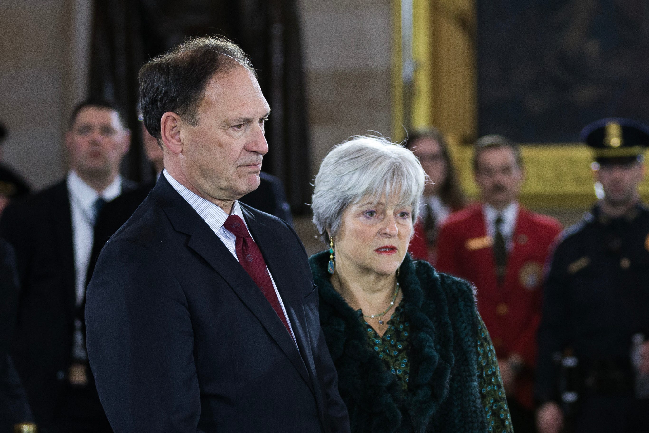 Supreme Court Justice Samuel Alito and his wife, Martha-Ann Alito, view the casket of the Rev. Billy Graham in the U.S. Capitol Rotunda in 2018. Two flags connected to the 