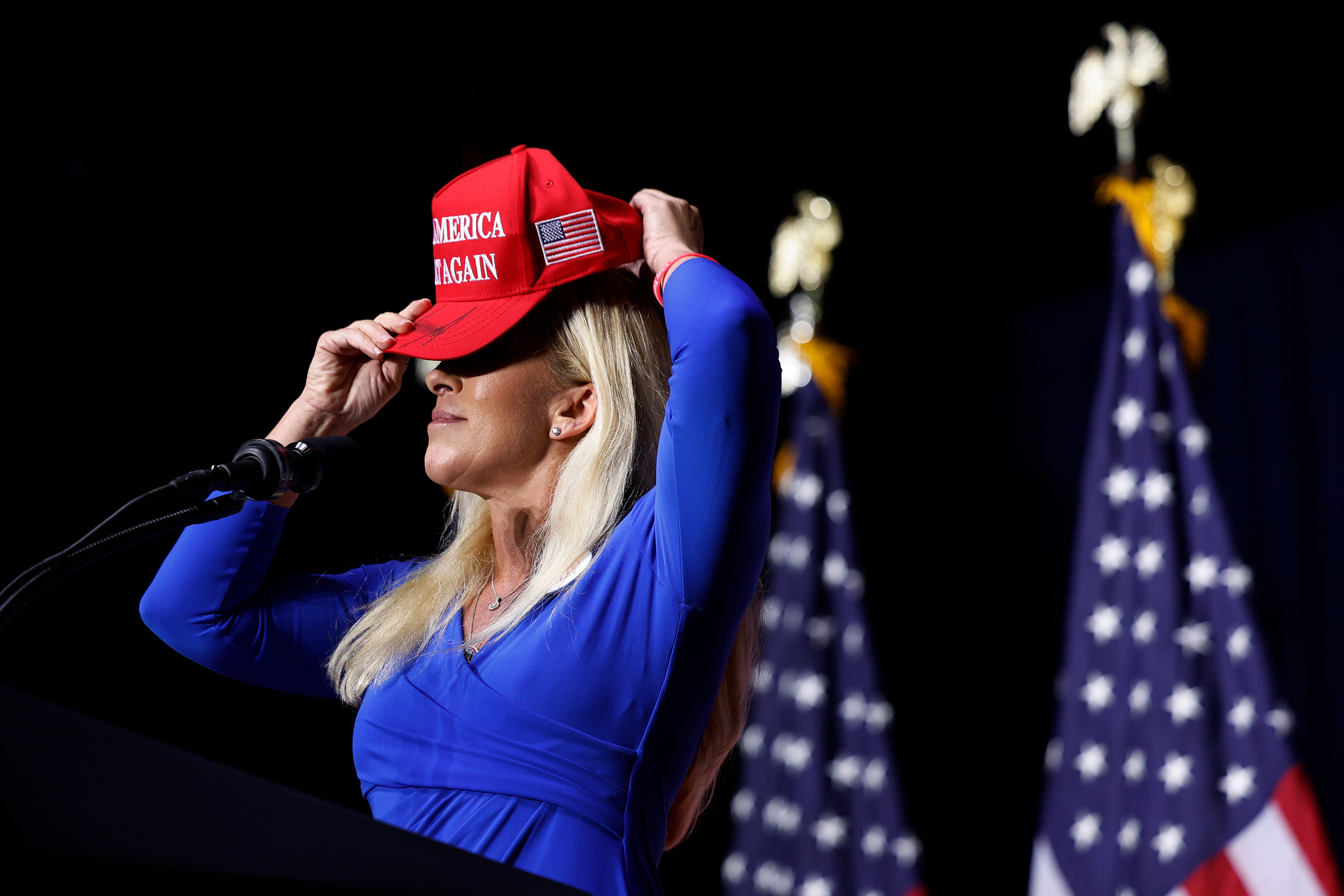 Rep. Marjorie Taylor Greene (R-GA) puts on her Make America Great Again hat while addressing a campaign rally with Republican presidential candidate and former President Donald Trump at the Forum River Center on March 9, 2024 in Rome, Georgia. A city of about 38,000, Rome is in the heart of conservative northwest Georgia and the center of Greene's district.