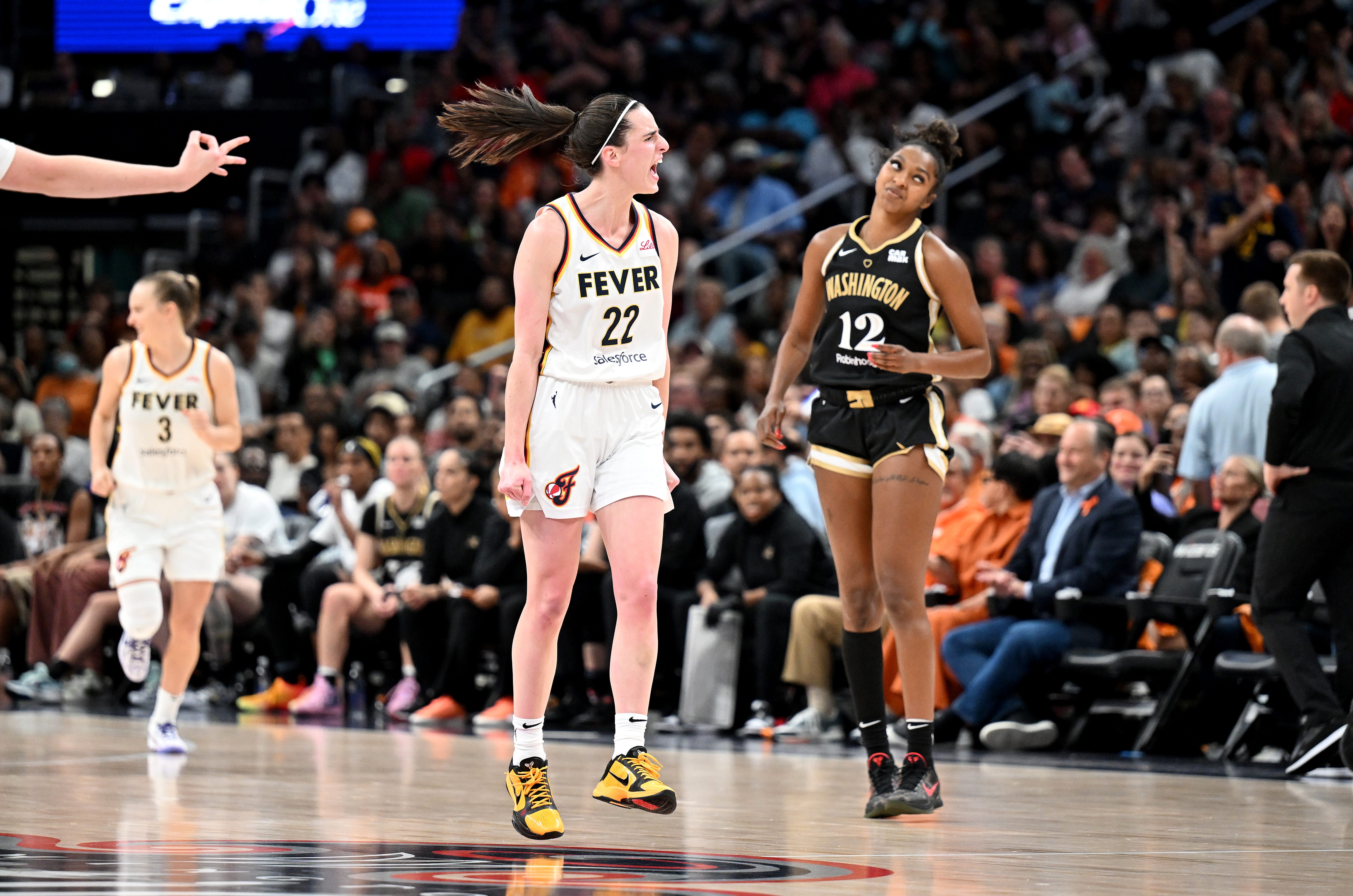 Caitlin Clark celebrates after scoring in the third quarter against the Washington Mystics.