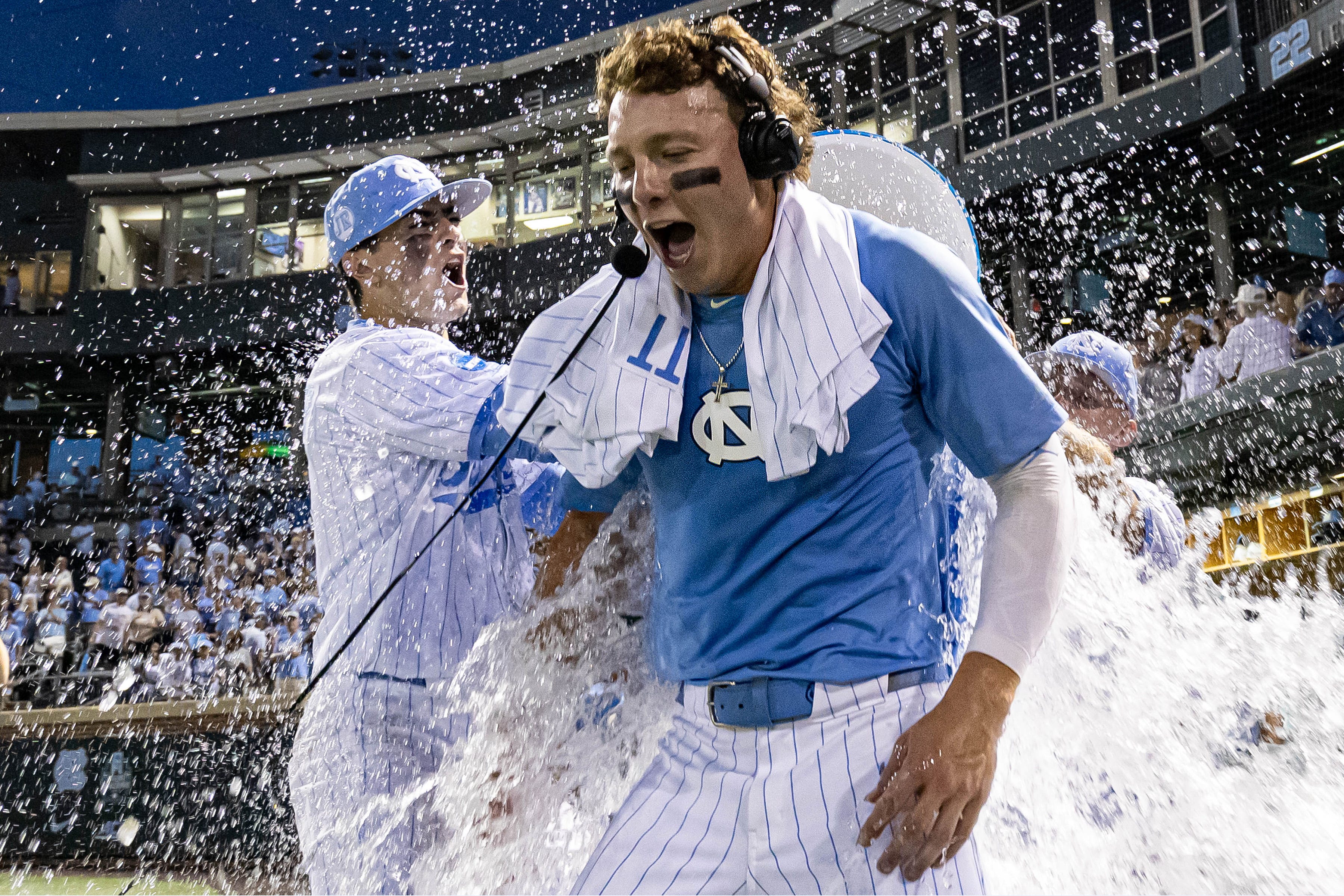 North Carolina Tar Heels Vance Honeycutt (7) is doused with water after his team defeated the West Virginia Mountaineers in the DI Baseball Super Regional at Boshamer Stadium.
