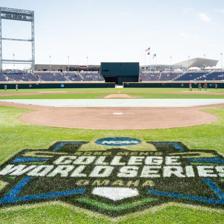 The 2022 NCAA College World Series logo is pictured on the field before the game between the Texas Longhorns and the Texas A&M Aggies at Charles Schwab Field.