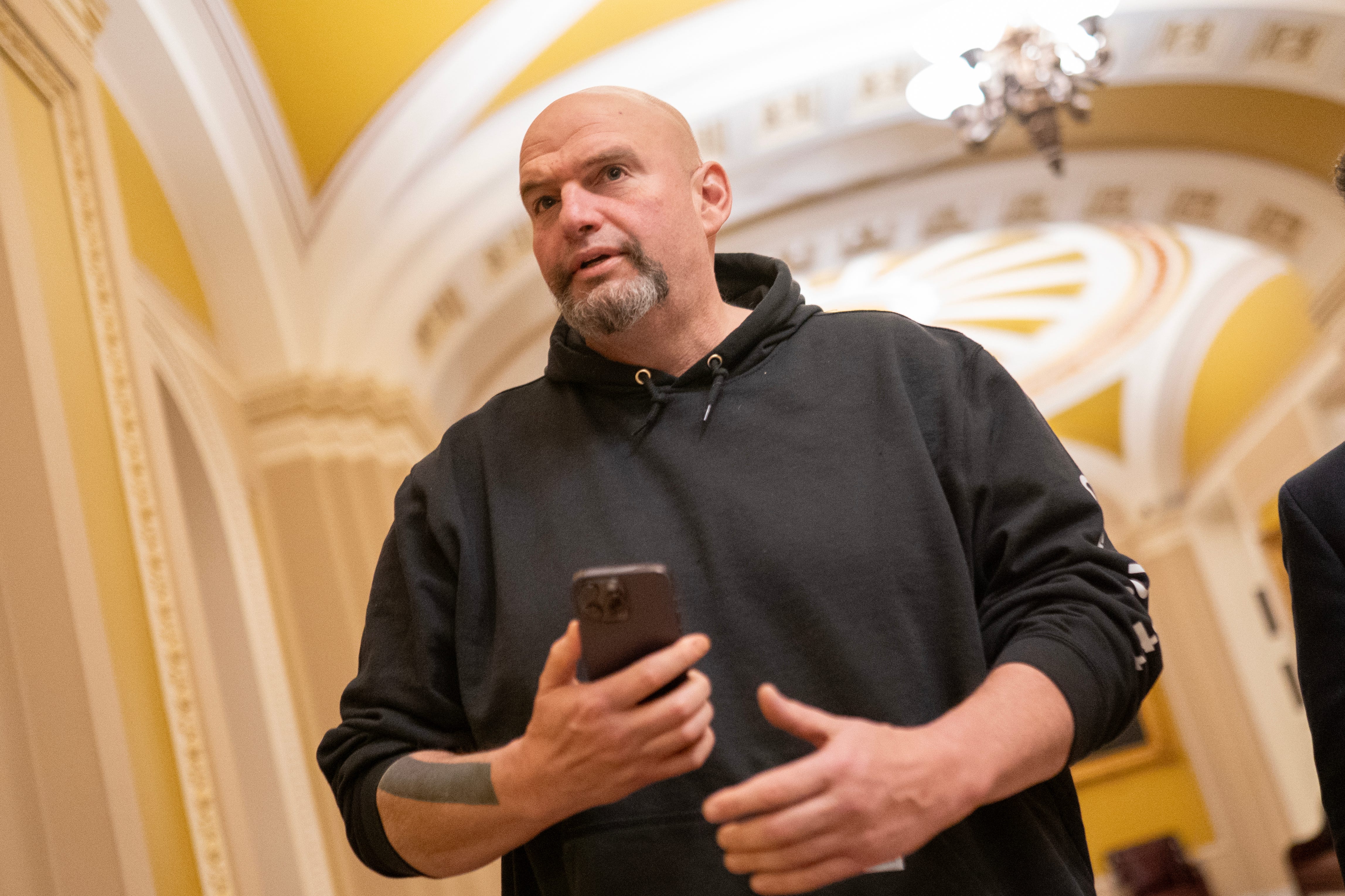 Sen. John Fetterman, D-Pa., walks toward the Senate Chambers on March 23, 2024 in Washington, DC.