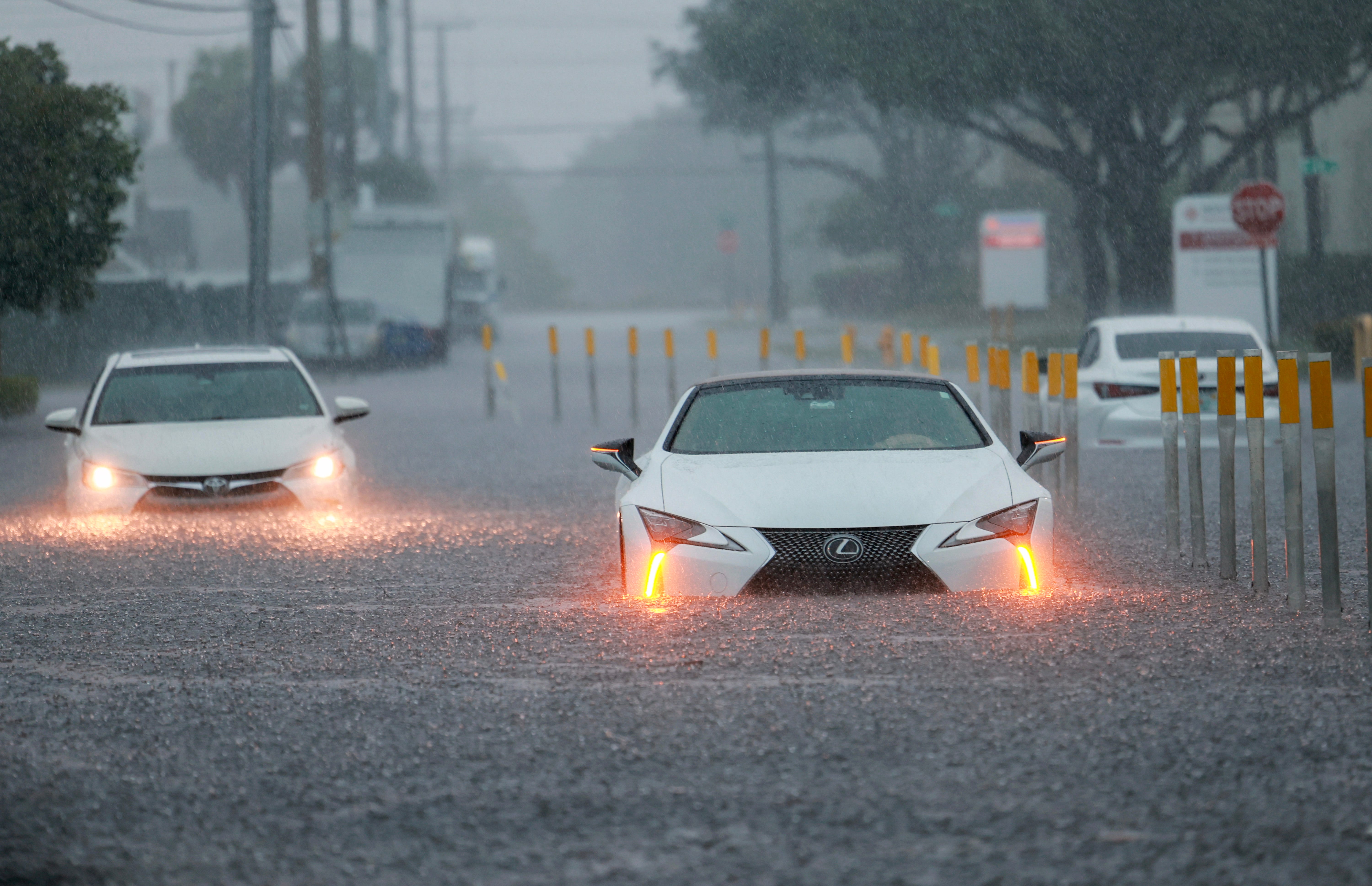 Stalled vehicles sit in a flooded street on June 12, 2024, in Aventura, Florida. The state is being adversely impacted as tropical moisture passes through the area.