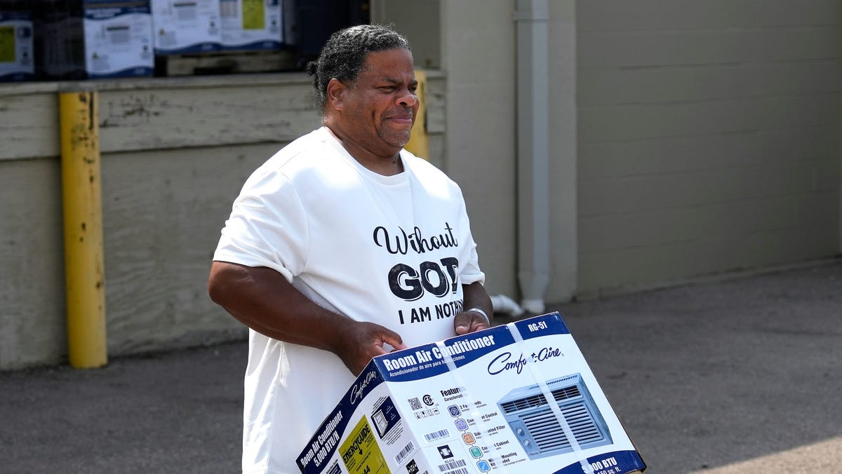 Albert Finnell picks up a room air conditioner from St. Vincent de Paul in Cincinnati on Monday, June 17, 2024. Finnell was getting the air conditioner for his neighbor, who just had major surgery. The community assistance agency started with 500 fans in May and now have only 25 left. They are actively fundraising to get more units.