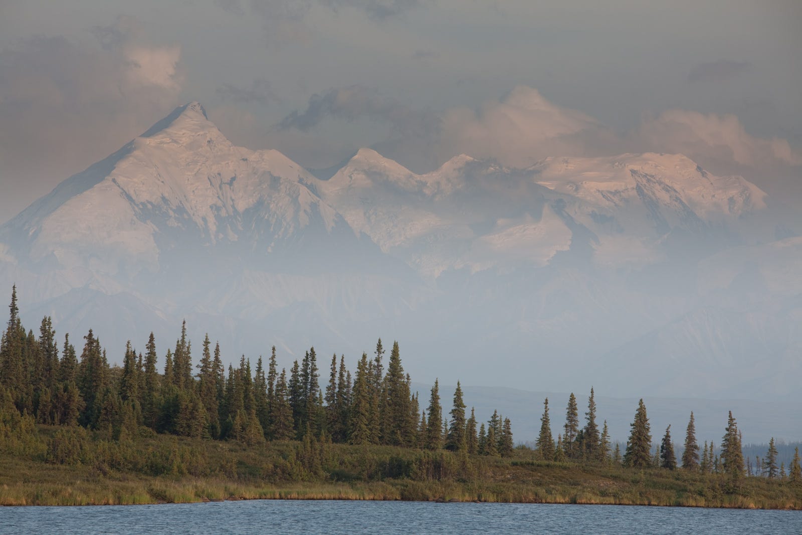Tall peaks in the Alaska Range tower over Wonder Lake near Kantishna in Denali National Park.