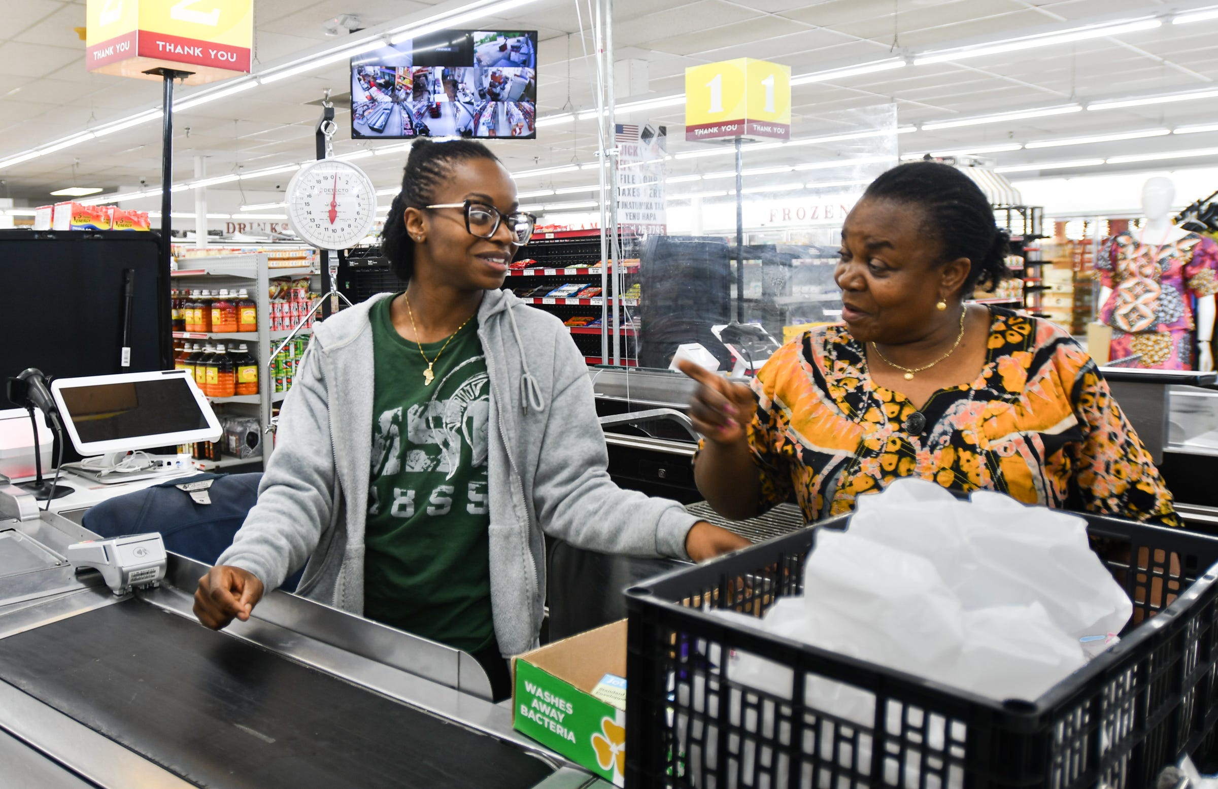 HanGa Ngandu, 27, left, and her mother Vumilia chat Tuesday, June 18, 2024, at their family's specialty grocery store in Kentwood, Mich. They specialize in African and other international goods and foods.