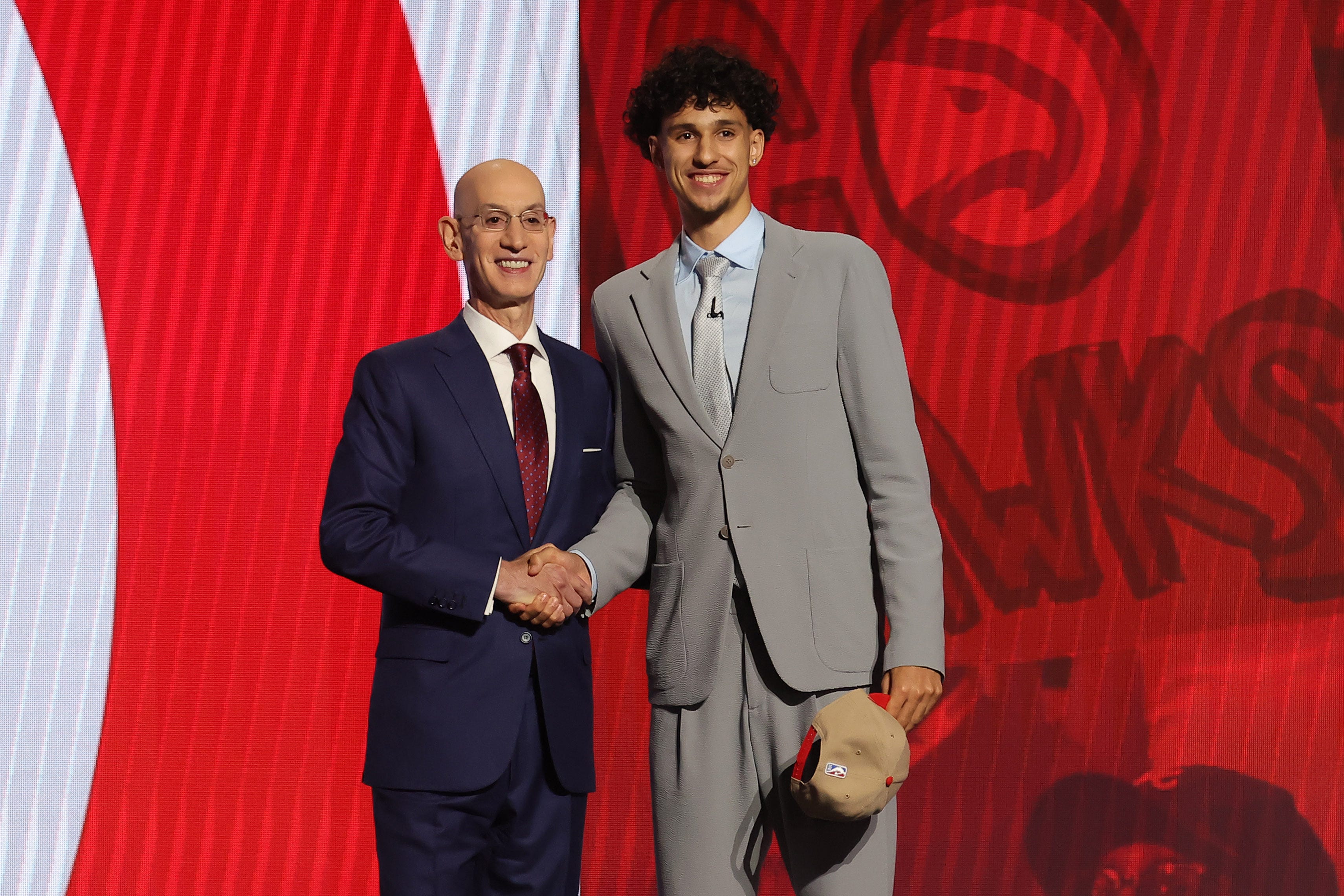 Zaccharie Risacher poses for photos with NBA commissioner Adam Silver after being selected first overall by the Atlanta Hawks in the 2024 NBA Draft.