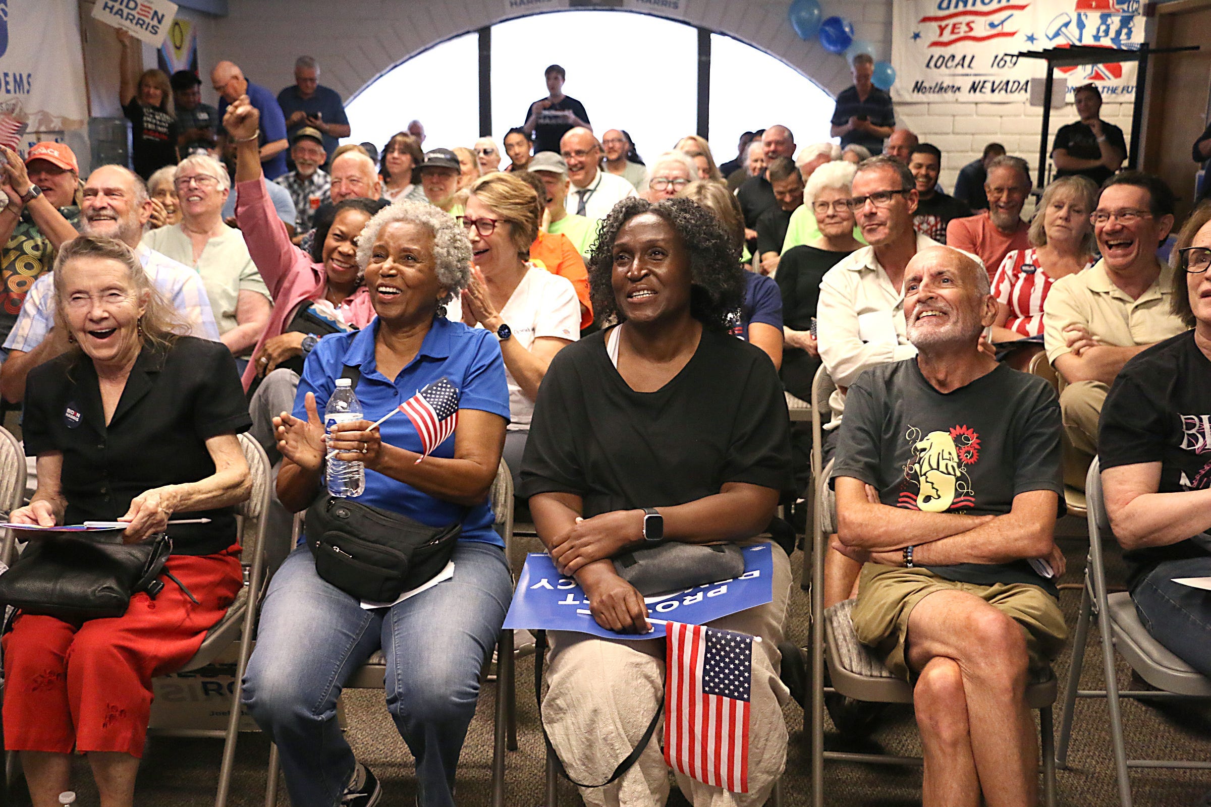 People react to something that President Biden said during the presidential debate at the Washoe County Democratic Party headquarters in Reno on June 27, 2024.