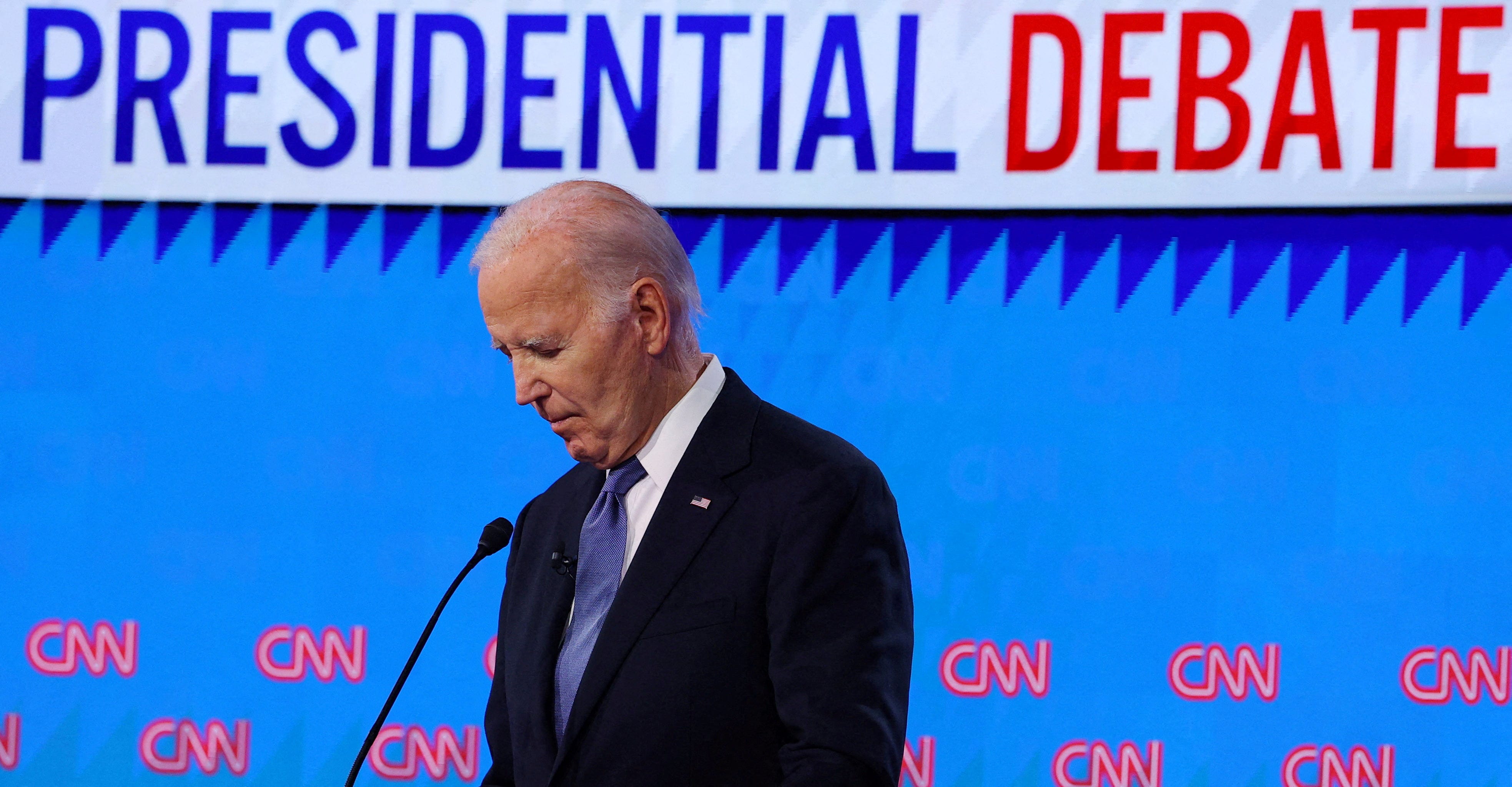 Democrat presidential candidate U.S. President Joe Biden listens as Republican presidential candidate and former U.S. President Donald Trump speaks during their debate in Atlanta, Georgia, U.S., June 27, 2024. REUTERS/Brian Snyder