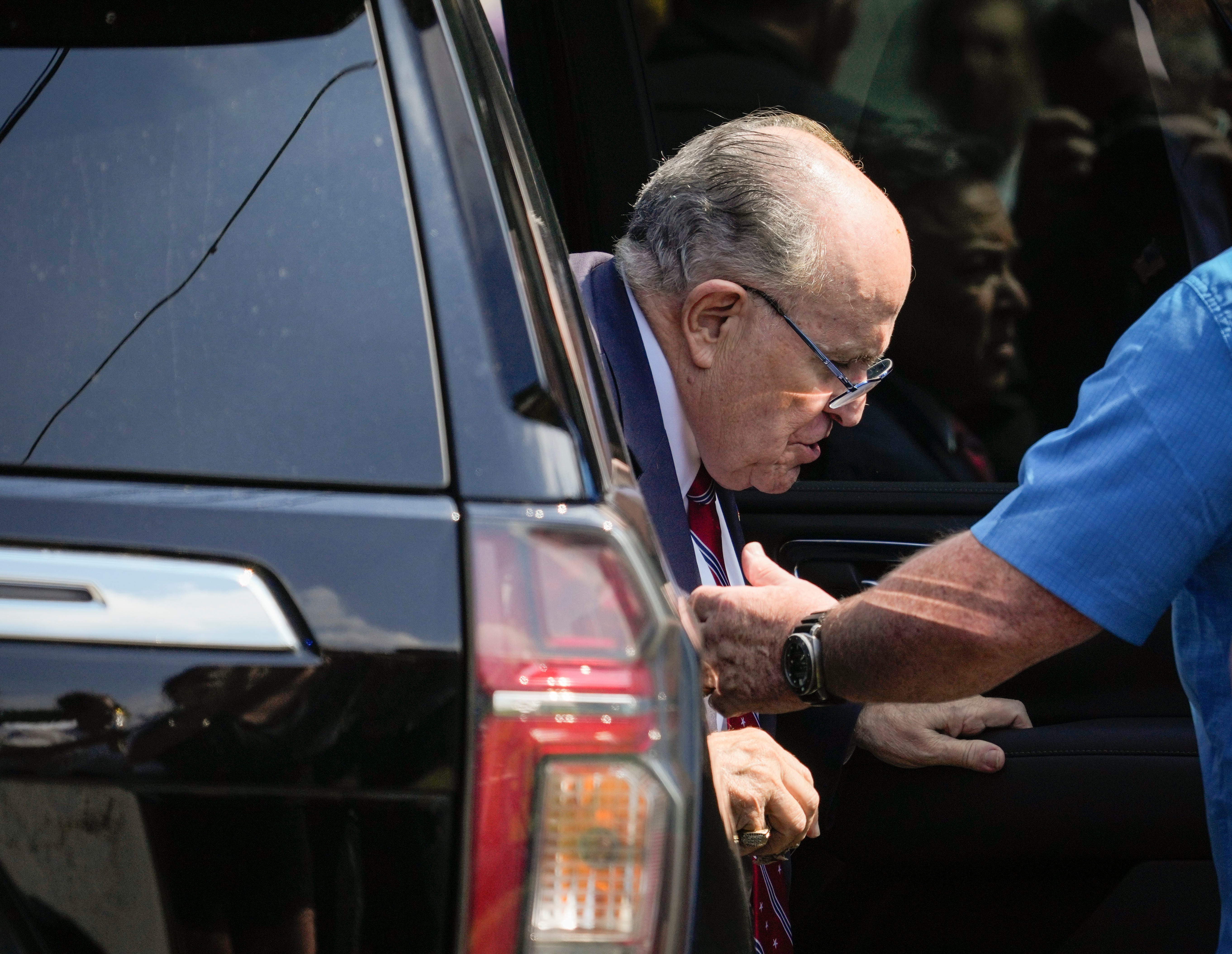 Rudy Giuliani exits his vehicle to speak with the media after he surrendered in Atlanta to be booked as part of county prosecutors' investigation into efforts to overturn the 2020 election in Georgia at the Fulton County Jail Intake Center in Atlanta, GA in Aug 23, 2023. A grand jury in Fulton County, Georgia indicted Donald Trump. The indictment includes 41 charges against 19 defendants, from the former president to his former attorney Rudy Guiliani and former   White House Chief of Staff Mark Meadows. The legal case centers on the stateâ€™s RICO statute, the Racketeer Influenced and Corrupt Organizations Act.