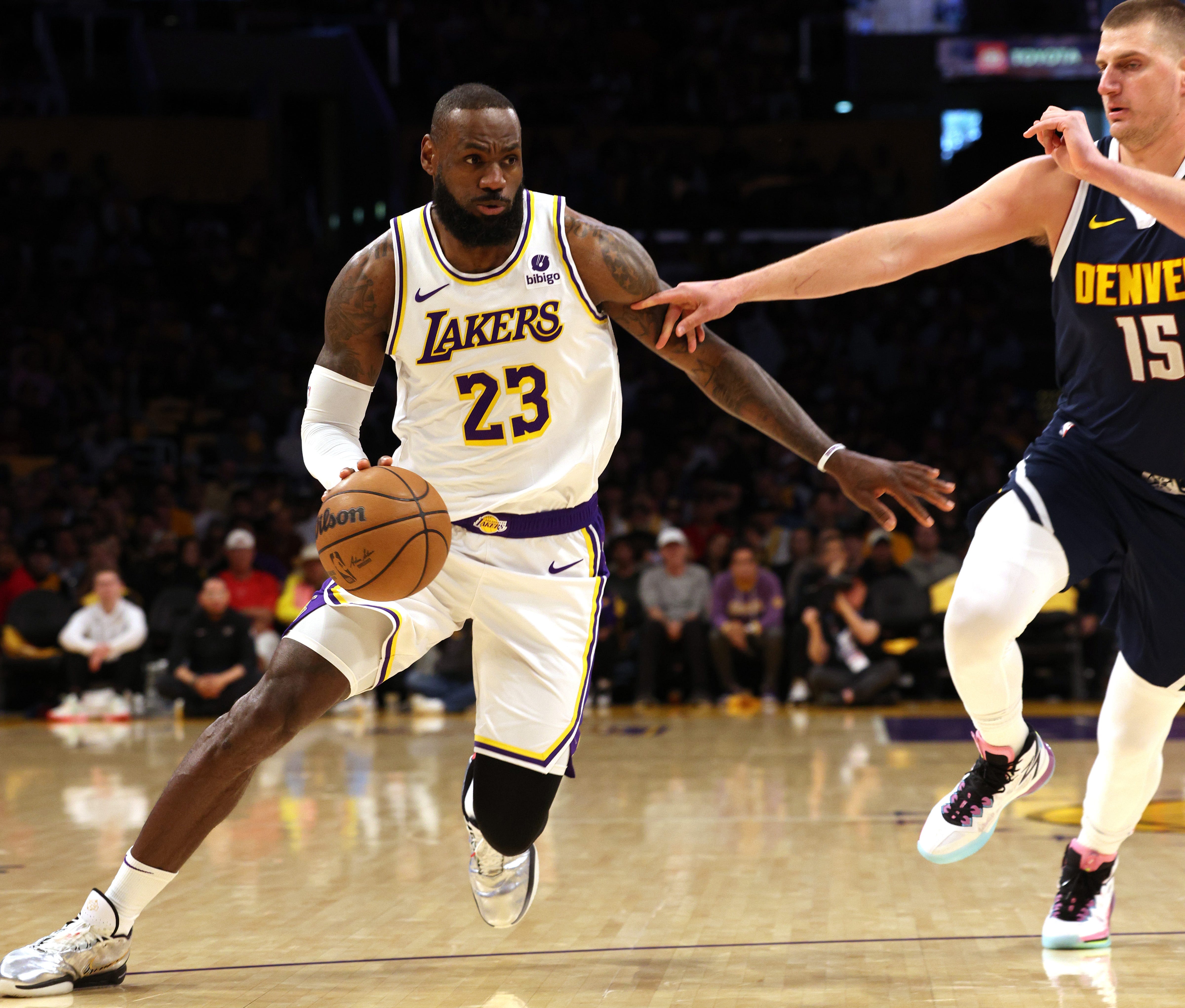 Lakers forward LeBron James (23) drives against Nuggets center Nikola Jokic (15) during the first quarter of Game 4 of their first round series during the NBA playoffs at Crypto.com Arena in Los Angeles on April 27, 2024.