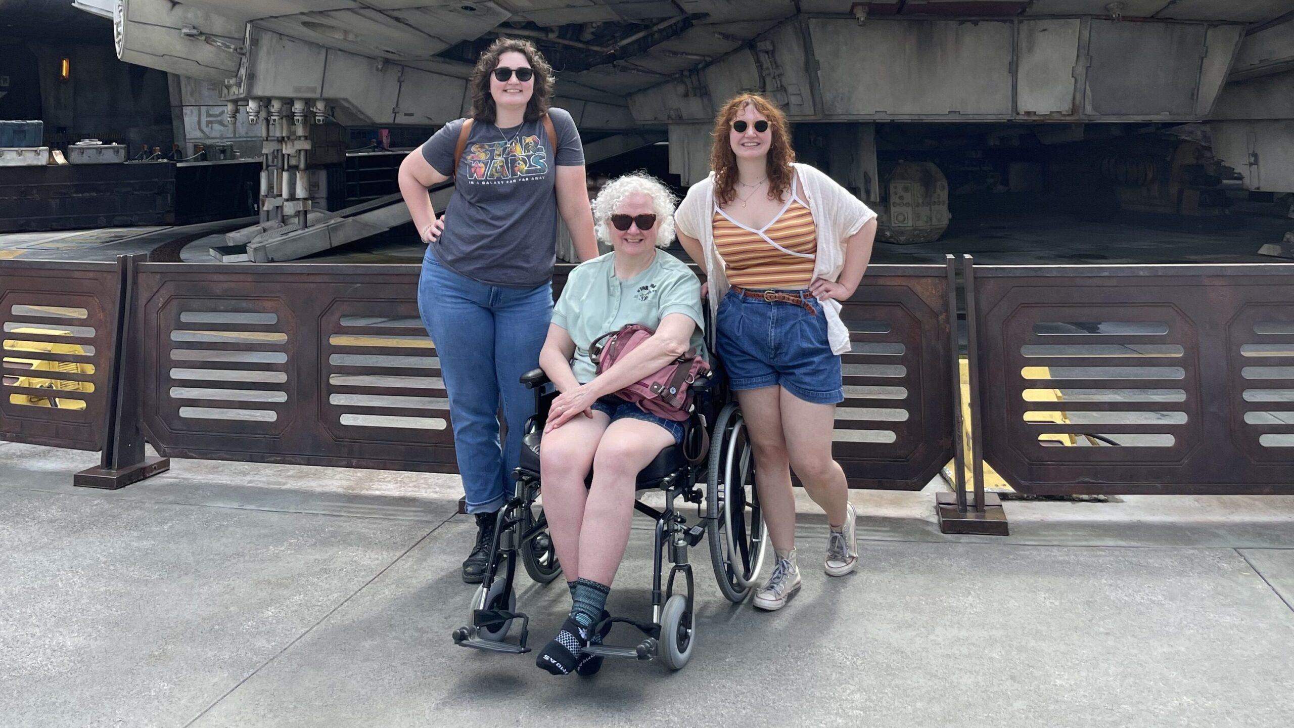 A family in front of the Millennium Falcon ride.