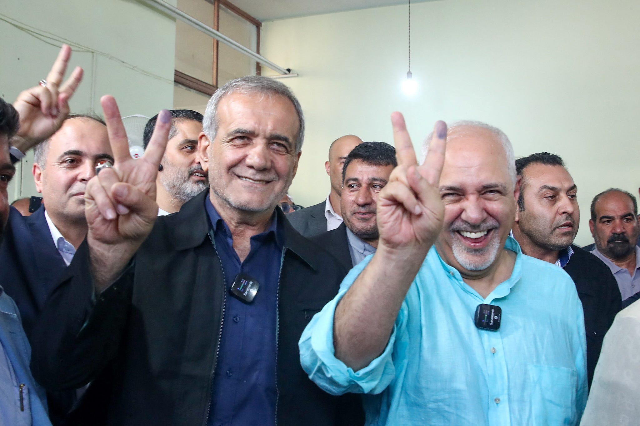 Iran's new president, Masoud Pezeshkian, left, waves at the crowd during the election campaign between him and Saeed Jalili, in Tehran, on July 5, 2024.