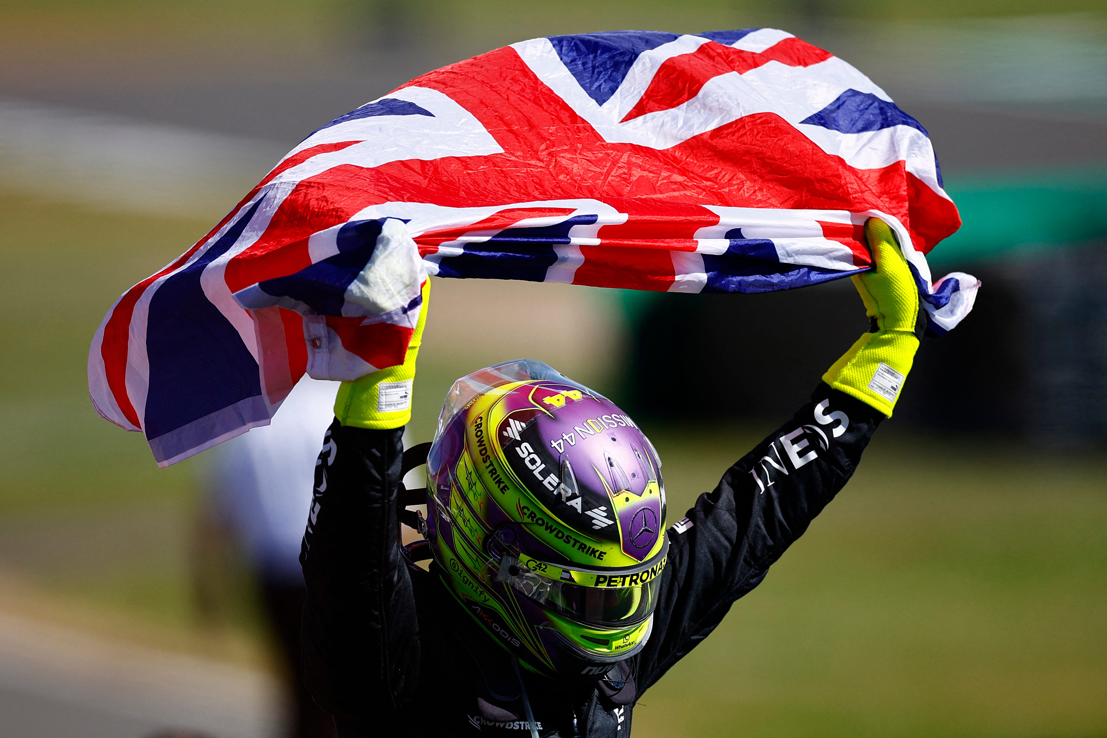 Mercedes' British driver Lewis Hamilton celebrates after winning the Formula One British Grand Prix.