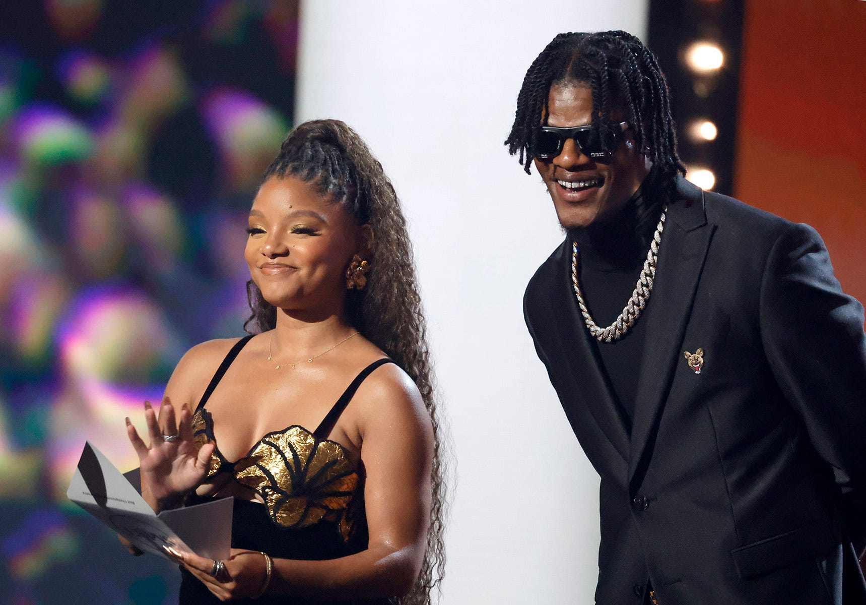 Halle Bailey and Lamar Jackson speak onstage.