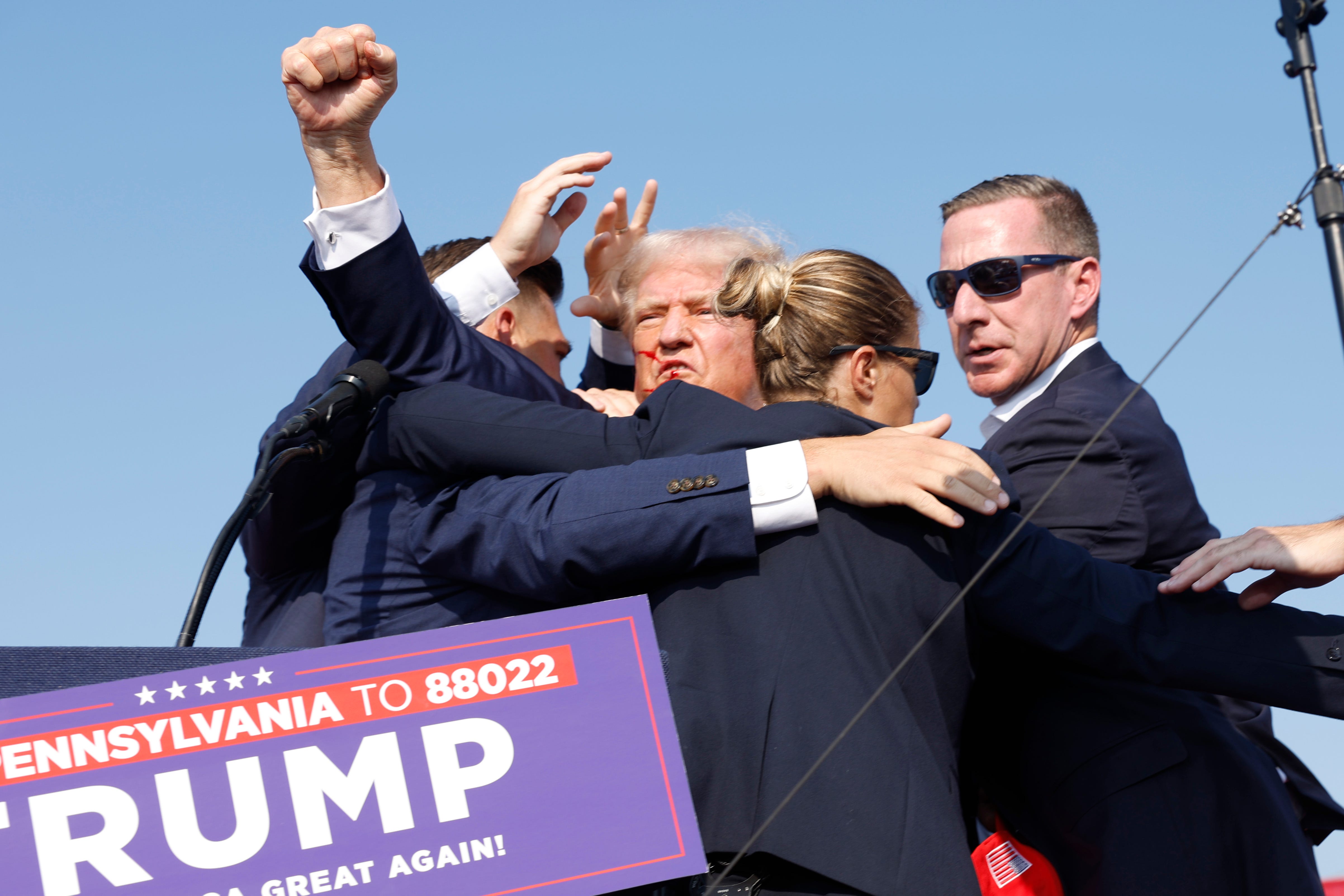 Secret Service agents help former President Donald Trump leave his reelection campaign rally on July 13, 2024, in Butler, Pa, after he was injured by gunfire.