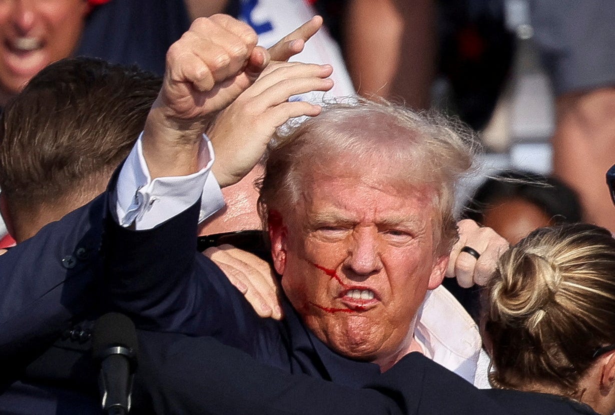 Republican presidential candidate and former U.S. President Donald Trump is assisted by the Secret Service after gunfire rang out during a campaign rally at the Butler Farm Show in Butler, Pennsylvania, U.S., July 13, 2024.