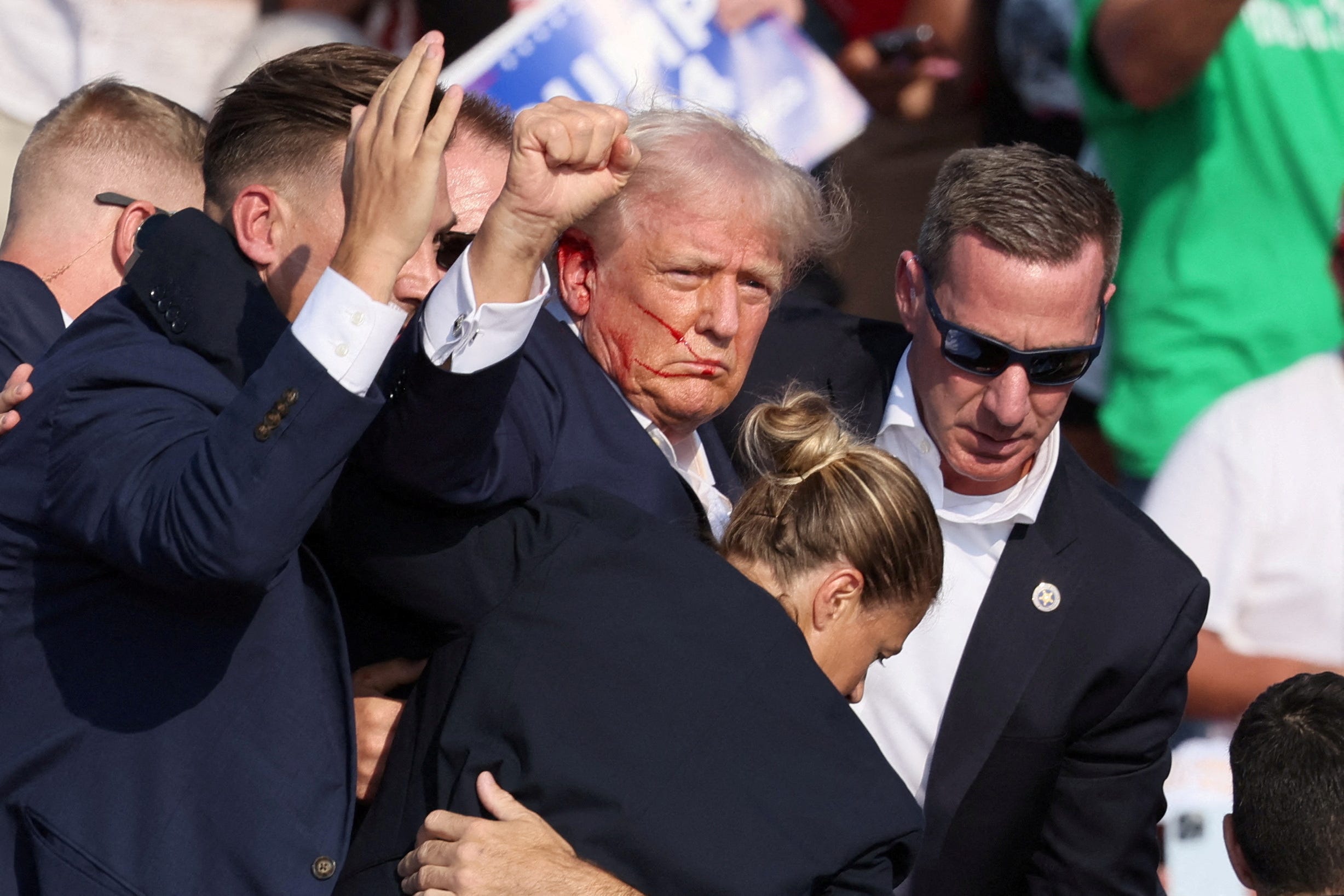 Secret Service agents help former President Donald Trump leave his reelection campaign rally in Butler, Pa., on July 13, 2024, after he was injured amid gunfire.