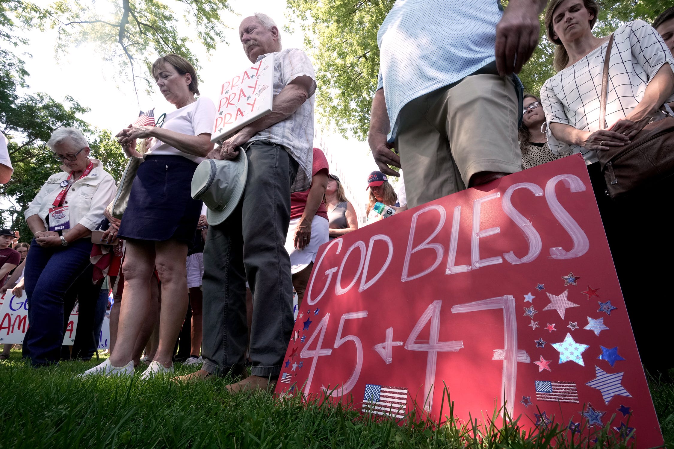 People bow their heads during a prayer during a Prayer Vigil for America Sunday, July 14, 2024 at Zeidler Union Square in Milwaukee, Wisconsin. The park is located five blocks from Fiserv Forum, site of the Republican National Convention that starts Monday.    Mark Hoffman/Milwaukee Journal Sentinel (Via OlyDrop)