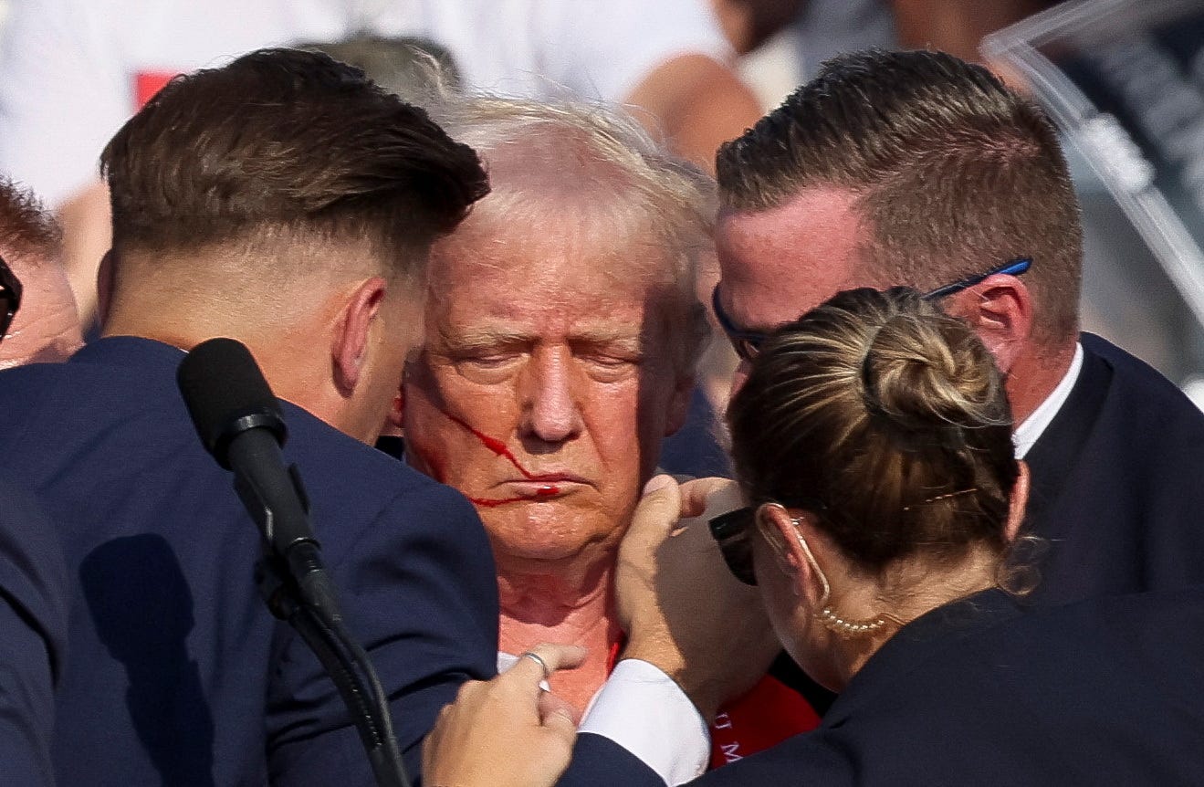 Secret Service agents help former President Donald Trump after he was injured amid gunfire at his reelection campaign rally on July 13, 2024, in Butler, Pa.