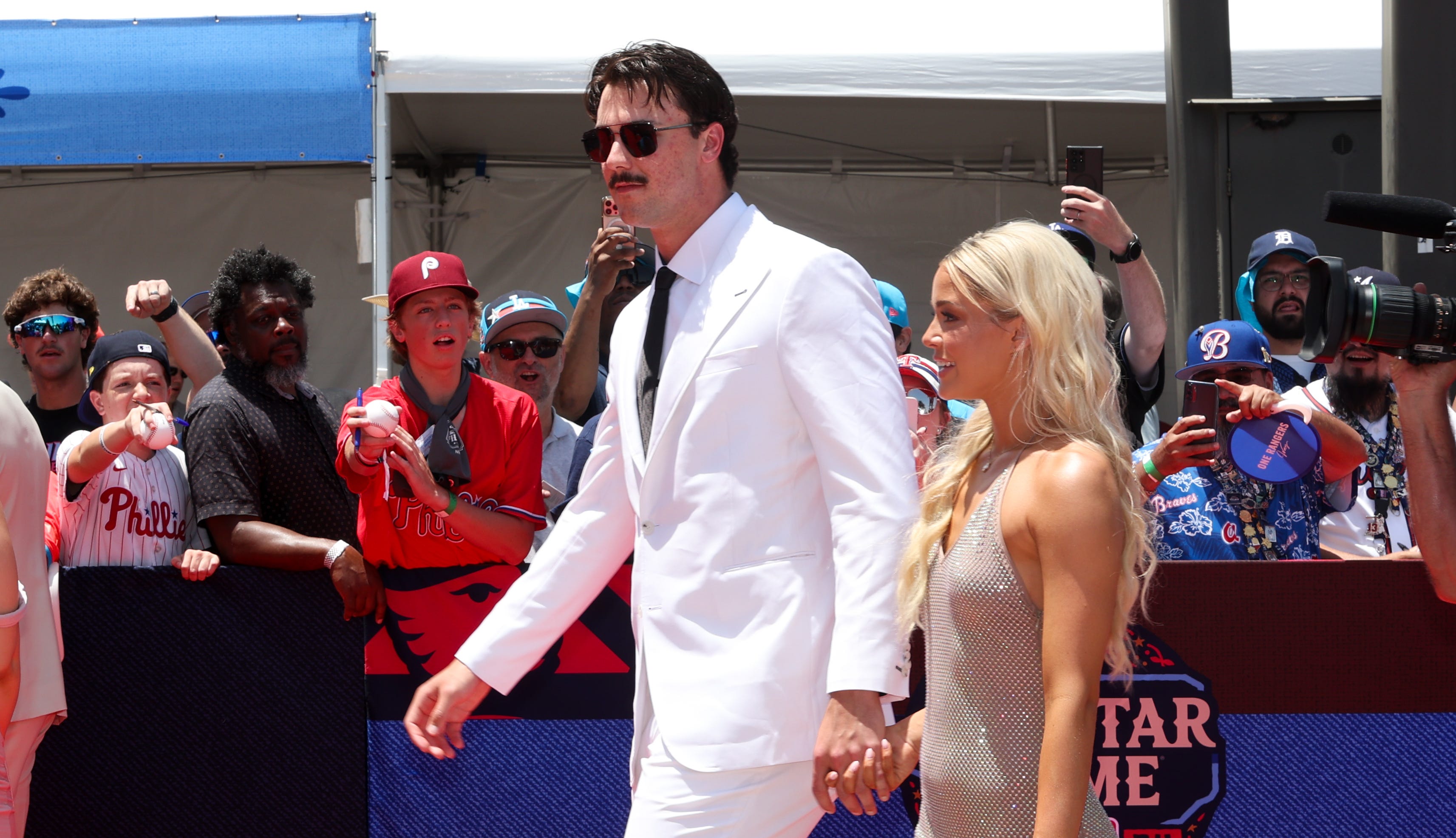 Pittsburgh Pirates pitcher Paul Skenes walks the red carpet with LSU gymnast and girlfriend Livvy Dunne before the 2024 MLB All-Star game at Globe Life Field.