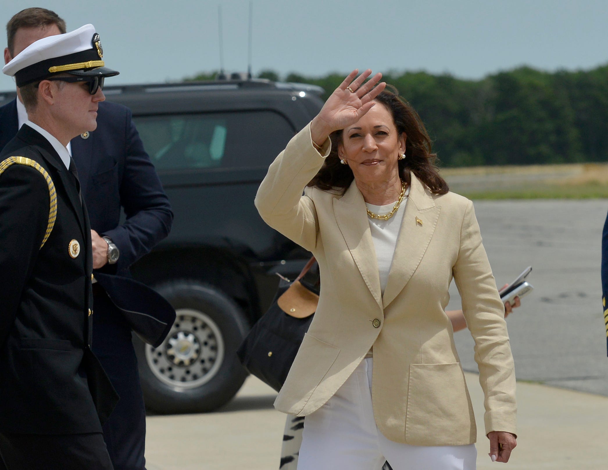 Vice President Kamala Harris waves to the group of press gathered under the wing of Air Force Two before getting into a vehicle for the drive up to Provincetown.   Vice President Kamala Harris arrived at Air Station Cape Cod Saturday, July 20, 2024. Air Force Two landed shortly before 1 p.m. at the Coast Guard air station. She was greeted by a group of officials before getting into a vehicle for a caravan to Provincetown. Harris attended a fundraiser at the Pilgrim Monument Saturday afternoon.   Merrily Cassidy/Cape Cod Times