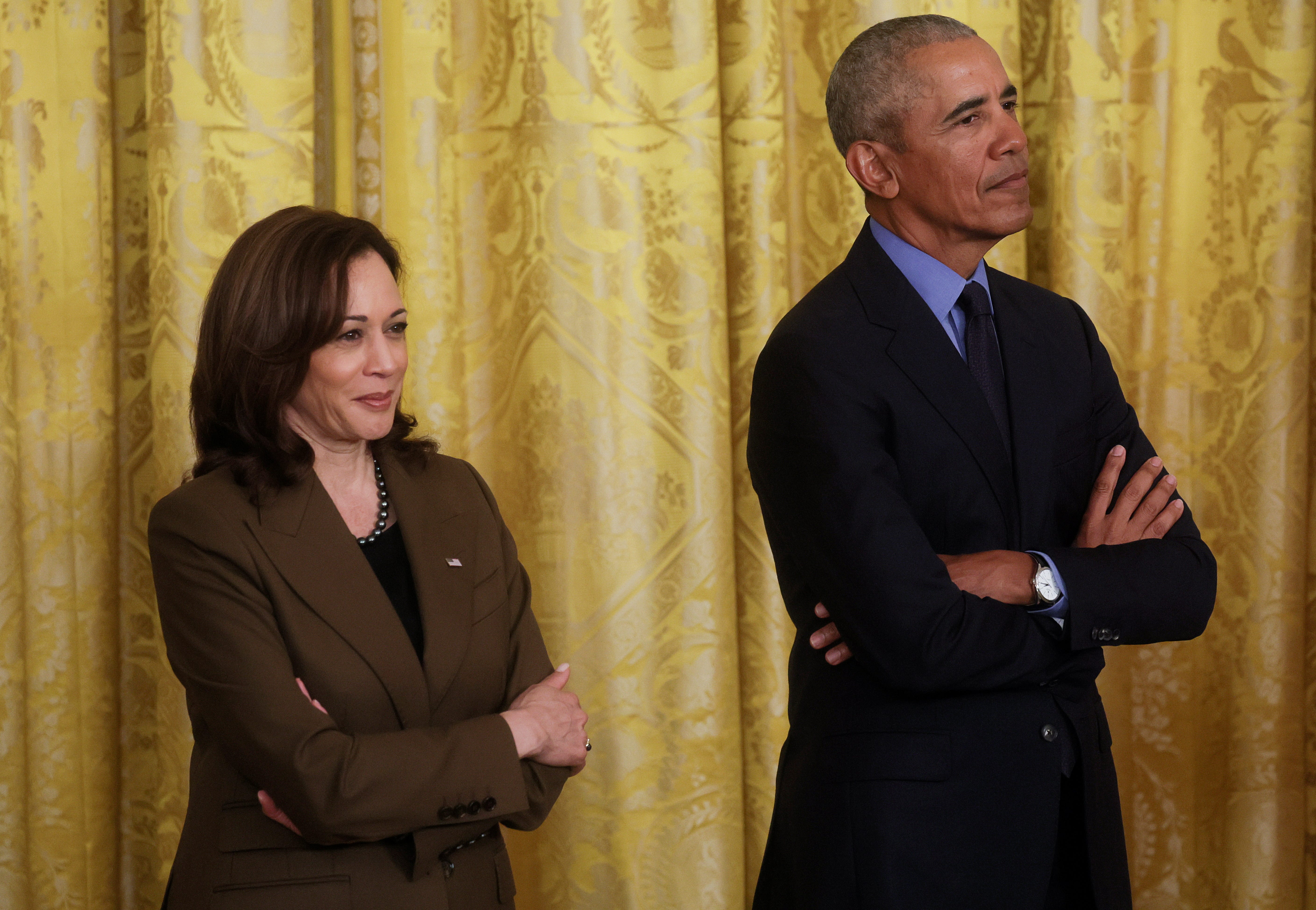 U.S. Vice President Kamala Harris stands with former President Barack Obama during an event hosted by U.S. Presdent Joe Biden on the Affordable Care Act, Obama's top legislative accomplishment, in the East Room at the White House in Washington, U.S., April 5, 2022. REUTERS/Leah Millis