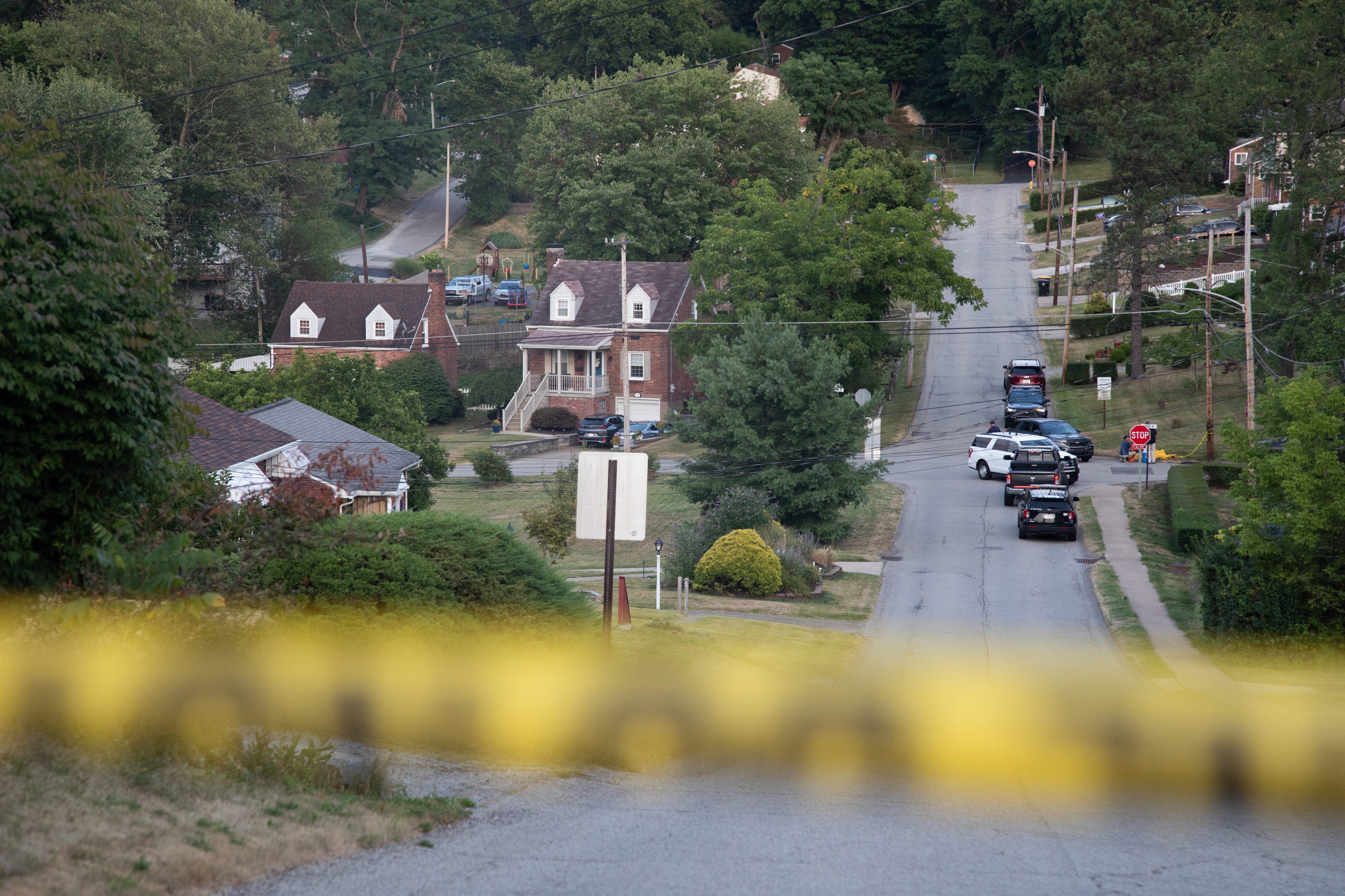Police continue to block roads around the home of Thomas Matthew Crooks as the FBI continues its investigation into the attempted assassination of former US President Donald Trump in Bethel Park, Pennsylvania, on July 14, 2024. Trump, the presumptive Republican presidential candidate, was shot in the ear July 13 in the opening minutes of his campaign rally in Butler.   Rivals Joe Biden and Donald Trump urged Americans to show unity on July 14, after an assassination attempt on the Republican that the FBI said was carried out by a shooter with a legally-bought semi-automatic rifle. (Photo by Rebecca DROKE / AFP) (Photo by REBECCA DROKE/AFP via Getty Images)